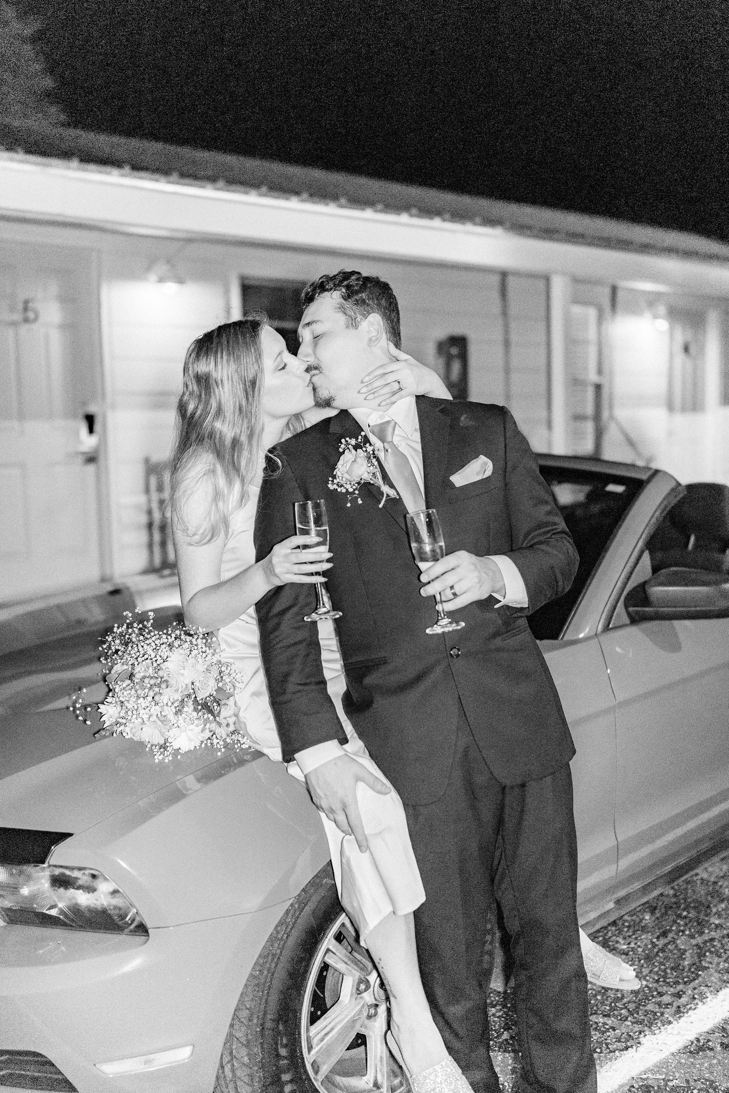 Series of black and white photos capturing intimate moments between newlyweds by a car southport elopement wedding bride groom light and air