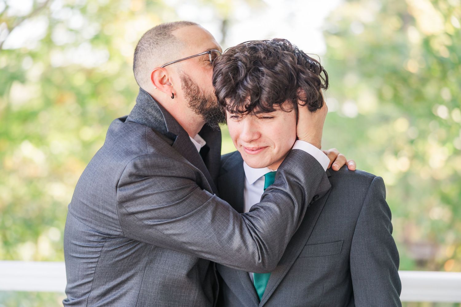 Two people in formal attire embrace while standing outdoors wedding groom bride lake Gaston photographer light airy