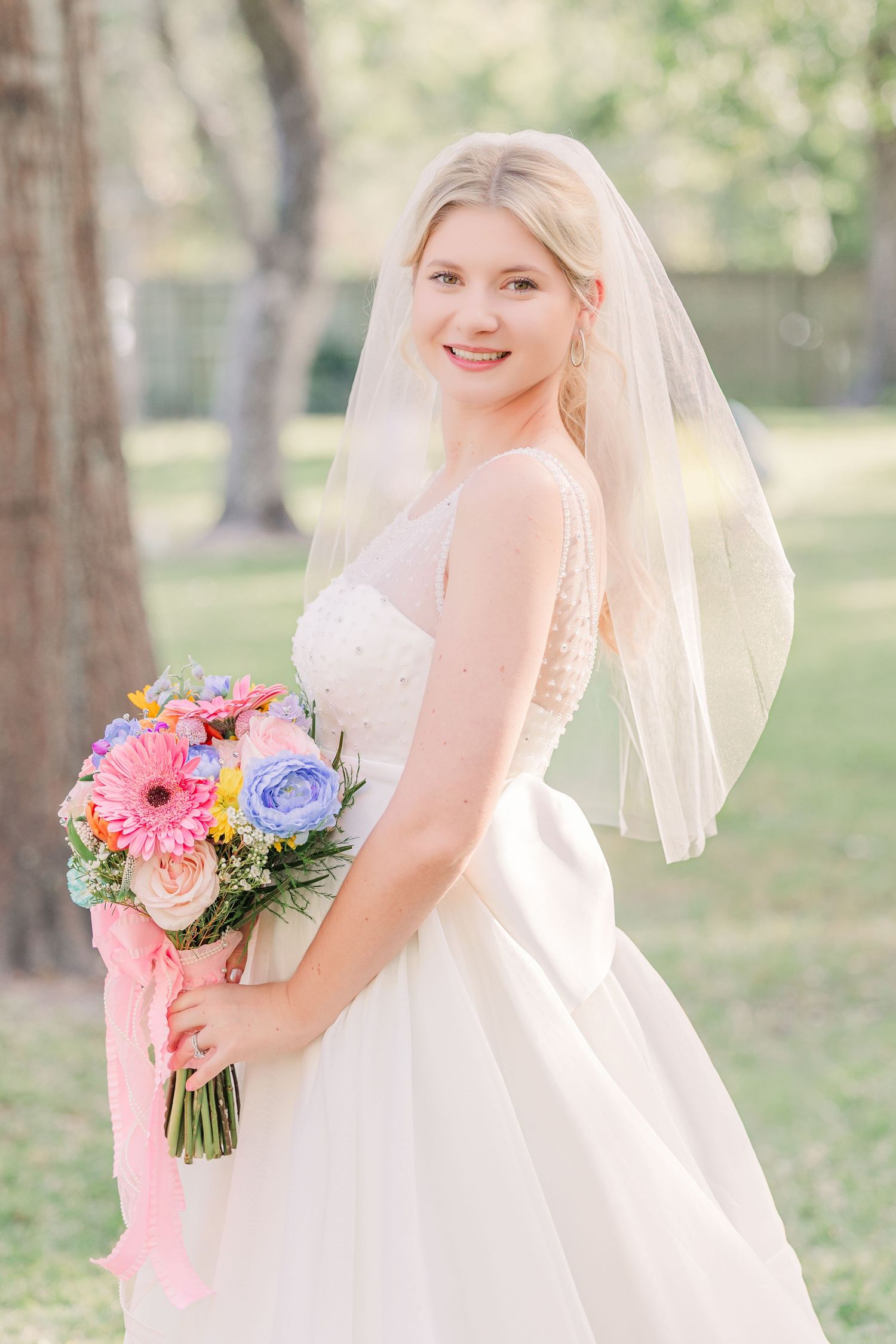 A bride holds a vibrant spring bouquet wedding groom bride wilmington photographer light and airy classic Wrightsville Beach