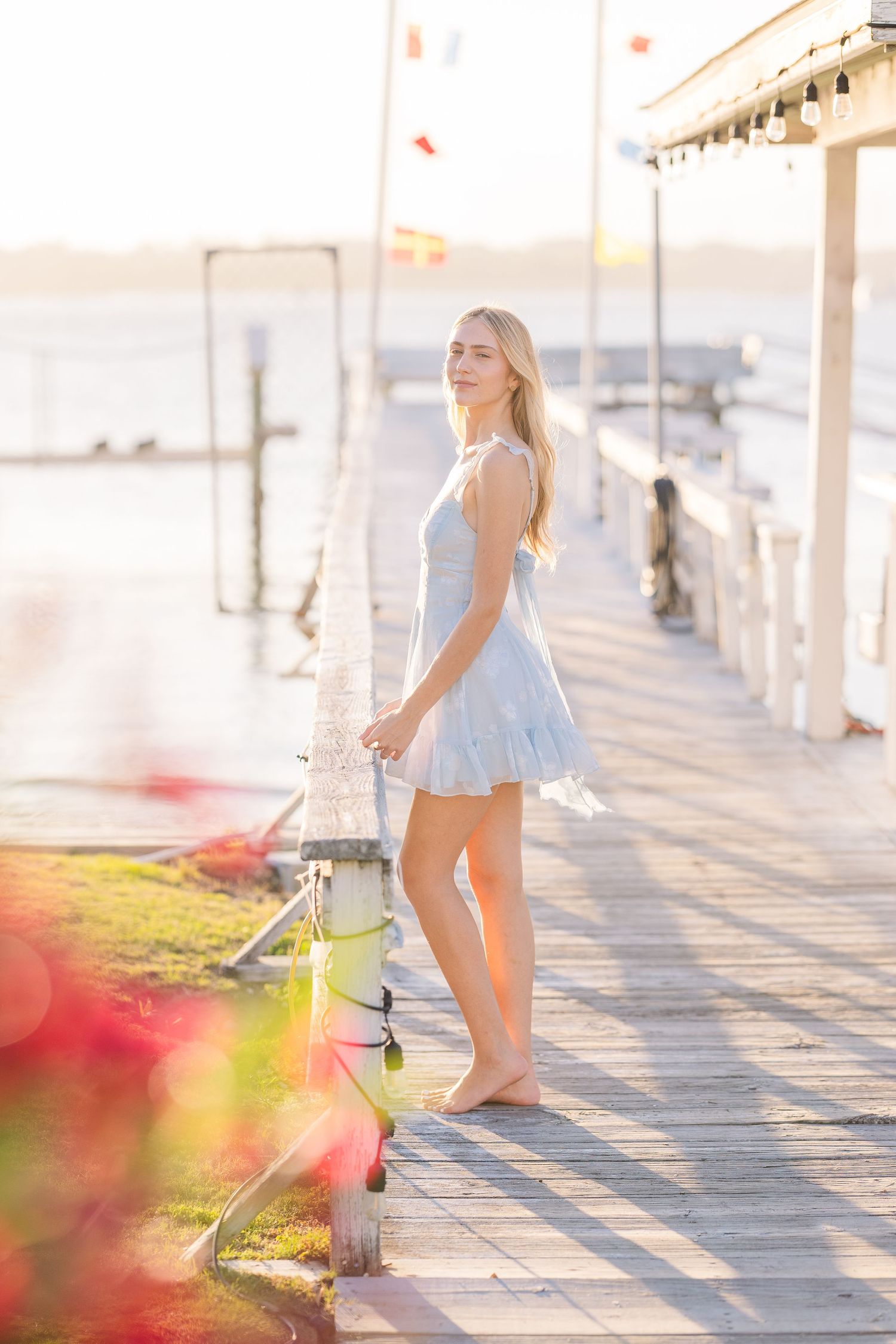 Summery scene on a wooden boardwalk with soft sunset lighting and coastal vibes.