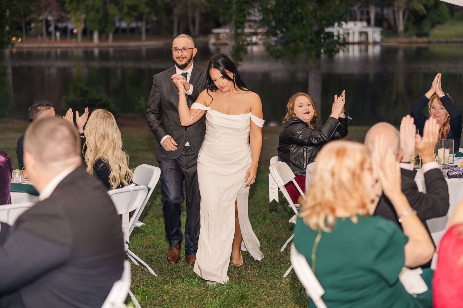 Outdoor wedding reception by a lake with guests enjoying the evening wedding groom bride lake Gaston photographer light airy