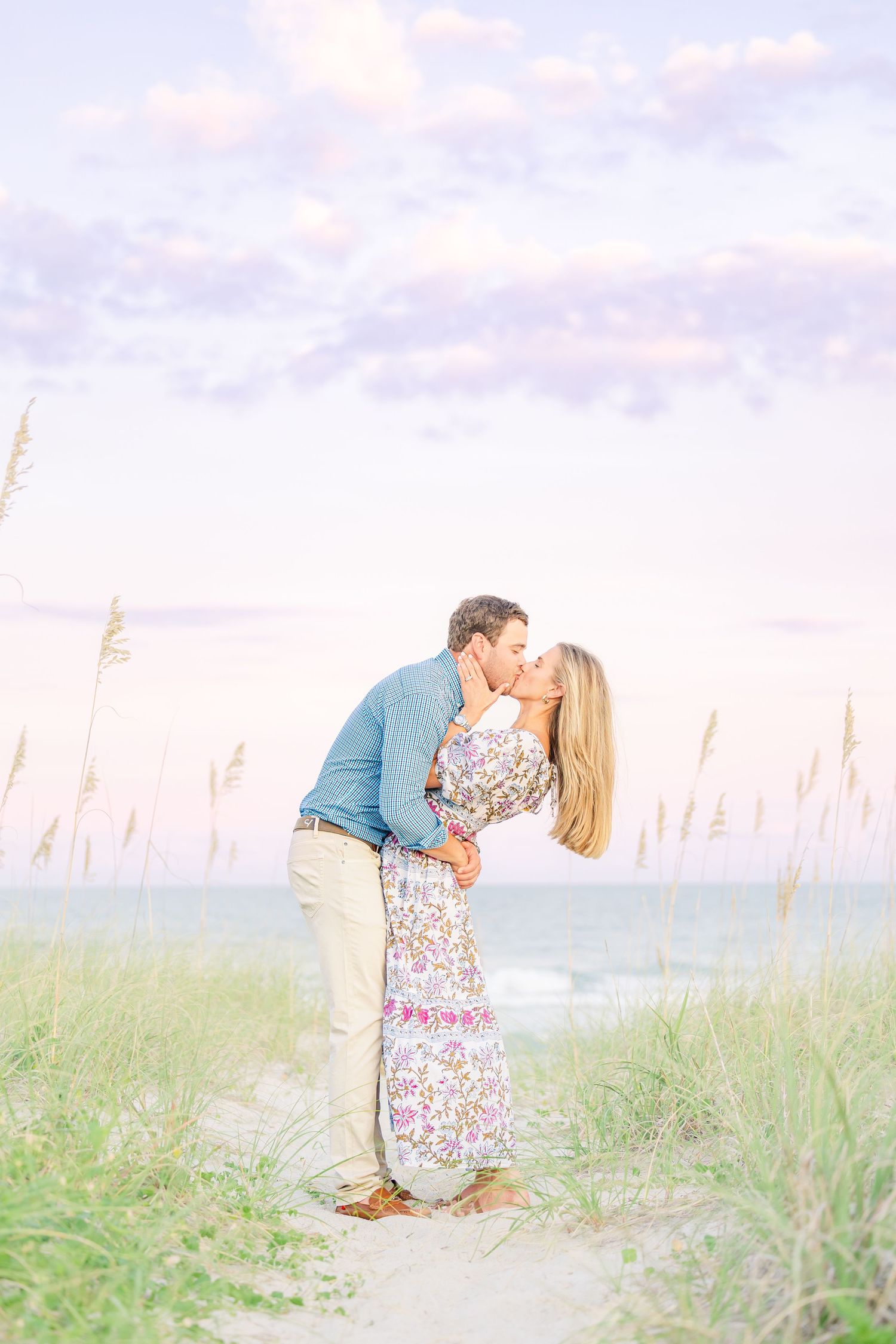 Sweet engagement session at sunset with sea oats and pastel sky along the shoreline Wrightsville Beach wedding classic light and airy