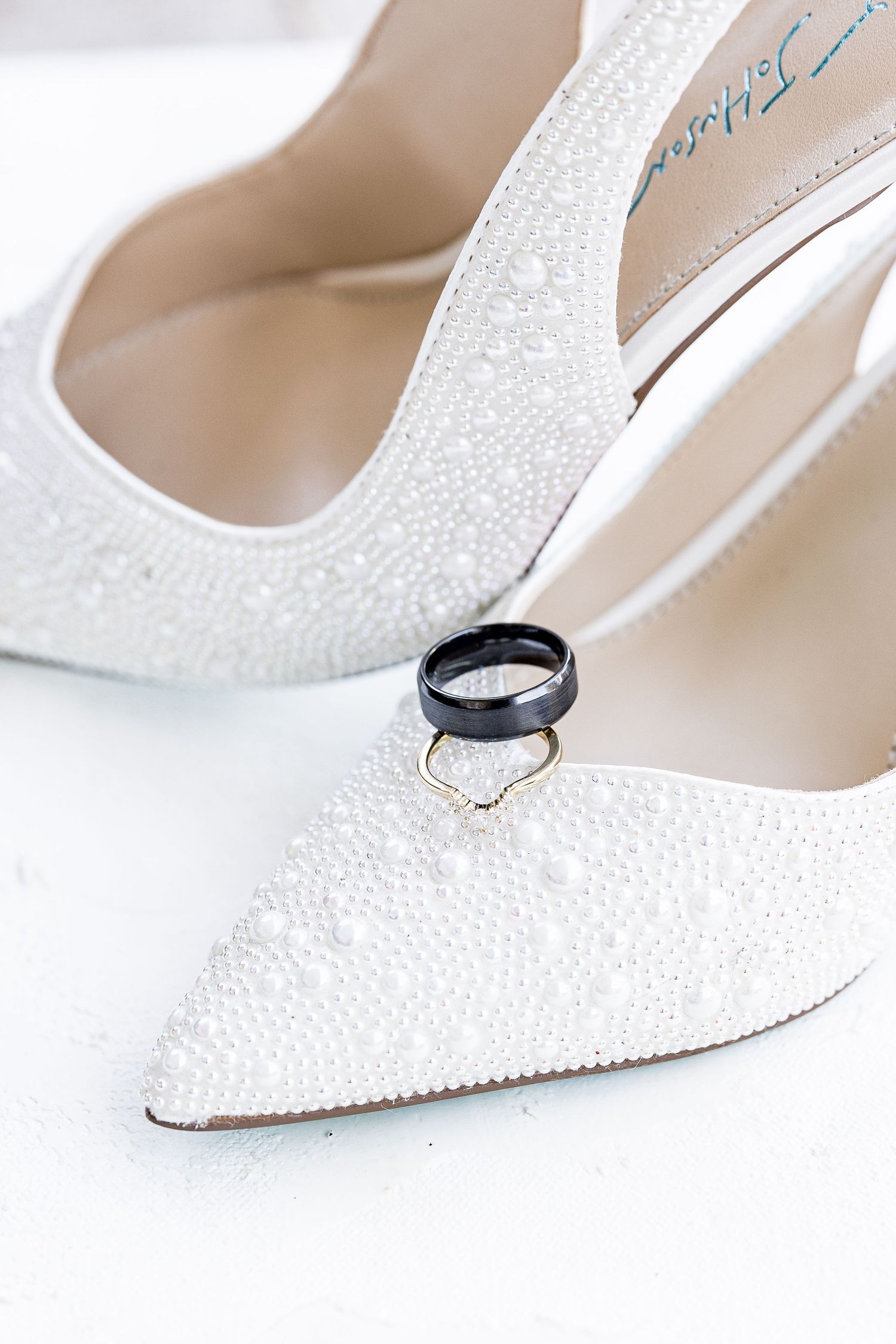 White sparkly bridal shoes with pointed toes displayed for wedding detail photography wedding groom bride lake Gaston photographer light air