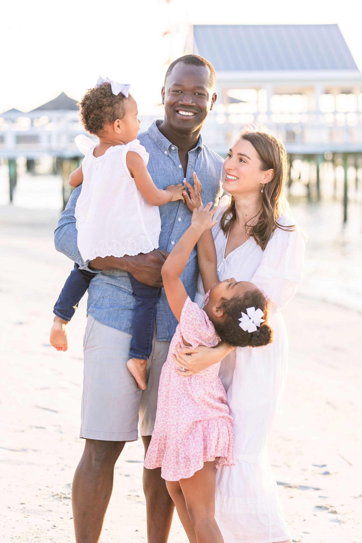 Candid family moments captured during sunset at the beach.
