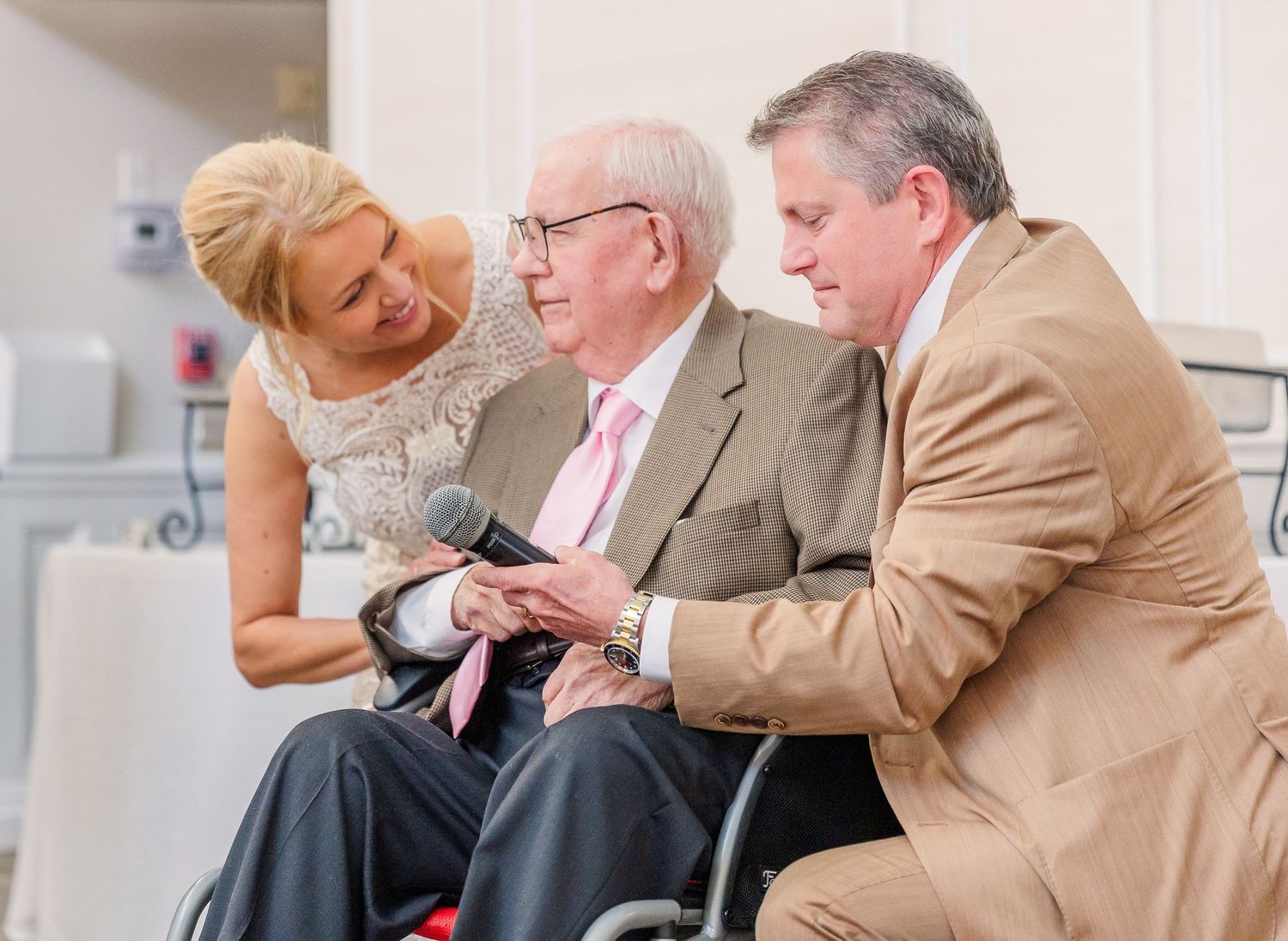 Intimate moments shared between wedding guests during an indoor reception celebration.