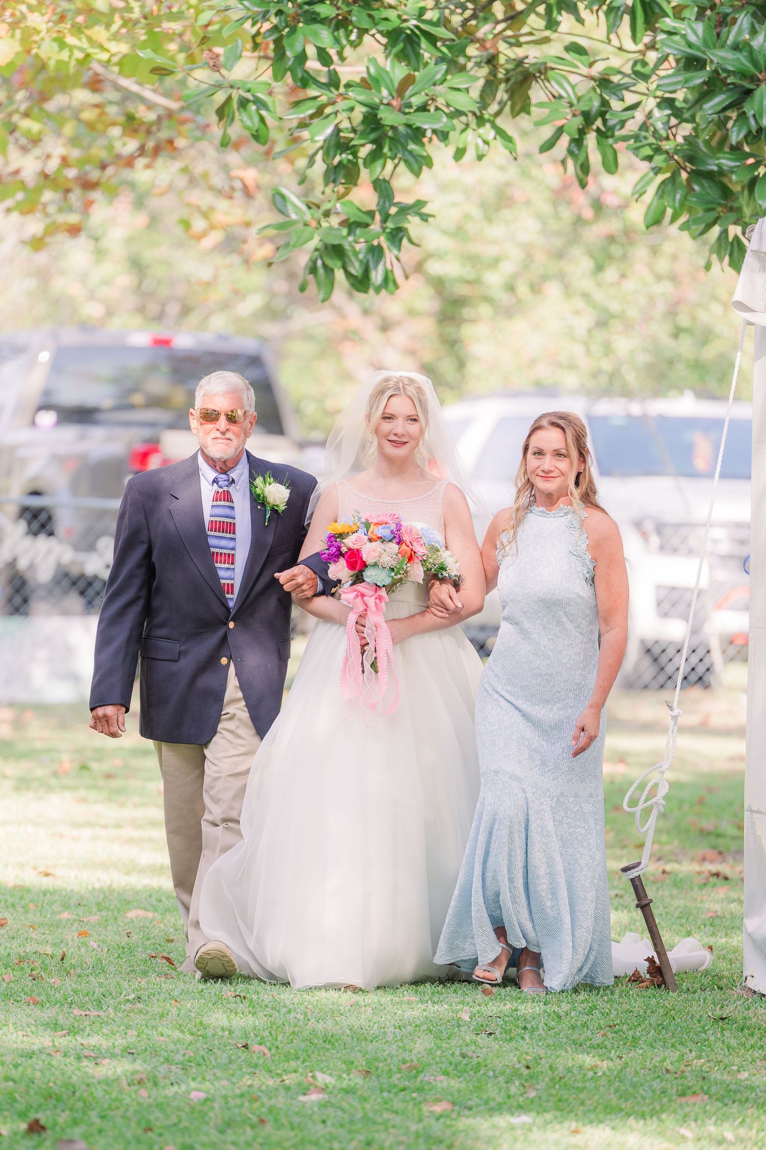 Wedding party poses on grass with trees wedding groom bride wilmington photographer light and airy classic Wrightsville Beach