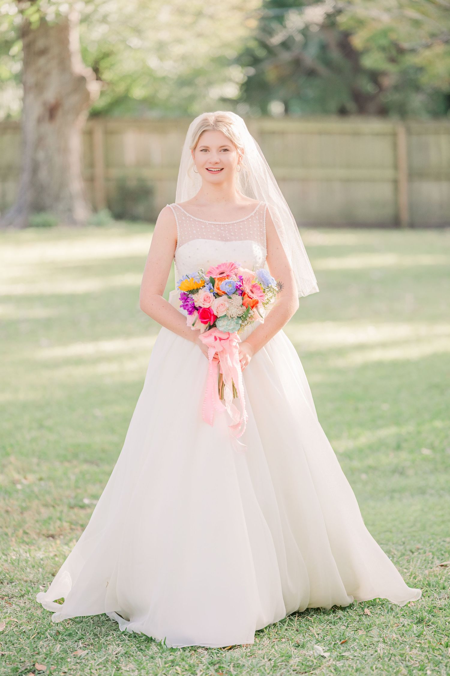 A bride in a ballgown style dress wedding groom bride wilmington photographer light and airy classic Wrightsville Beach