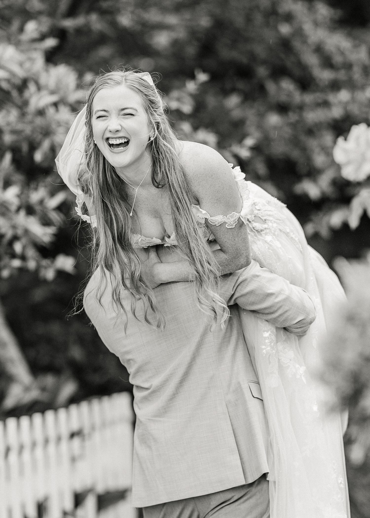 Joyful candid black and white portraits showing laughter and natural expressions outdoors in harborway gardens in Wrightsville Beach, nc