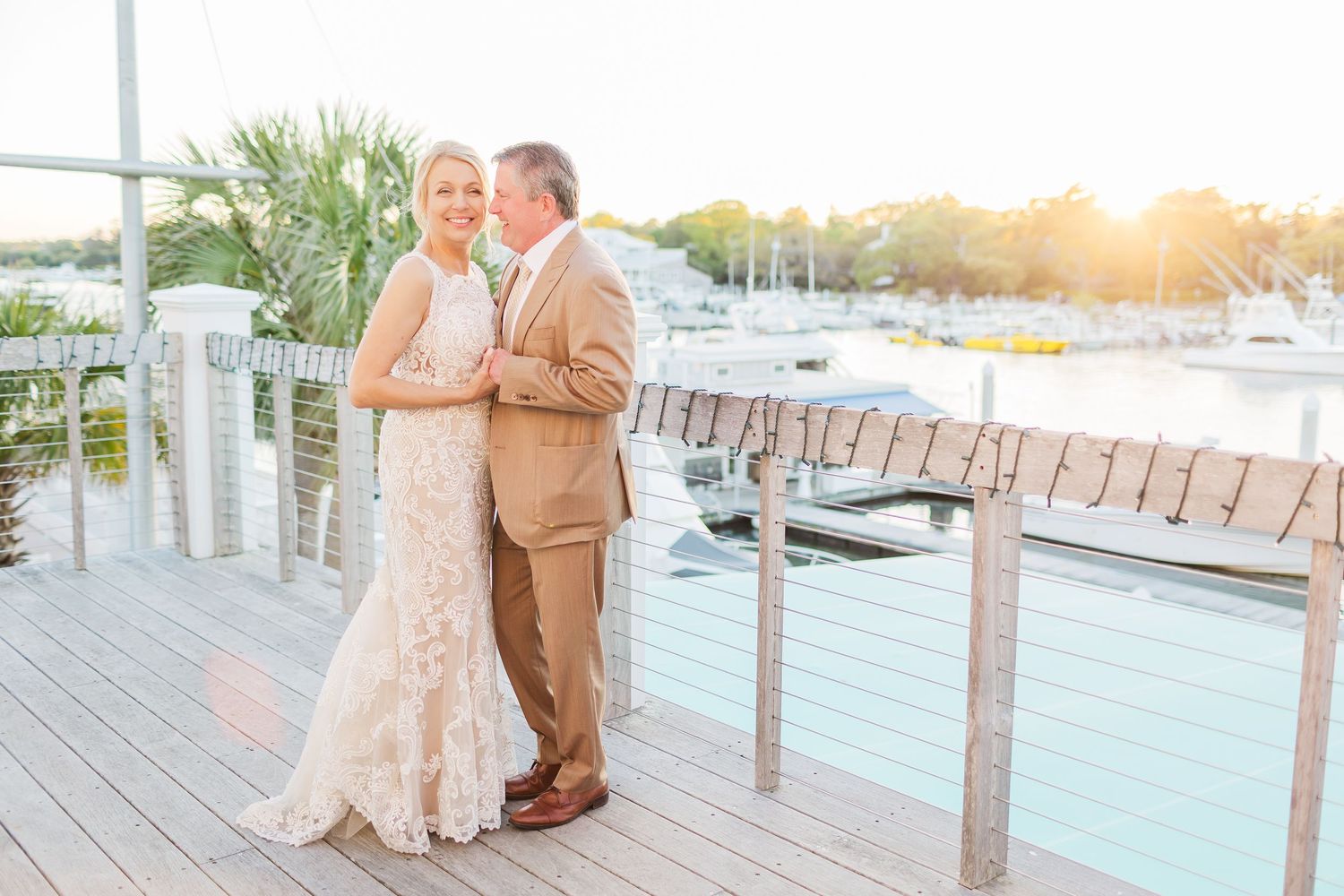 Elegant waterfront wedding celebration with marina views at golden hour.