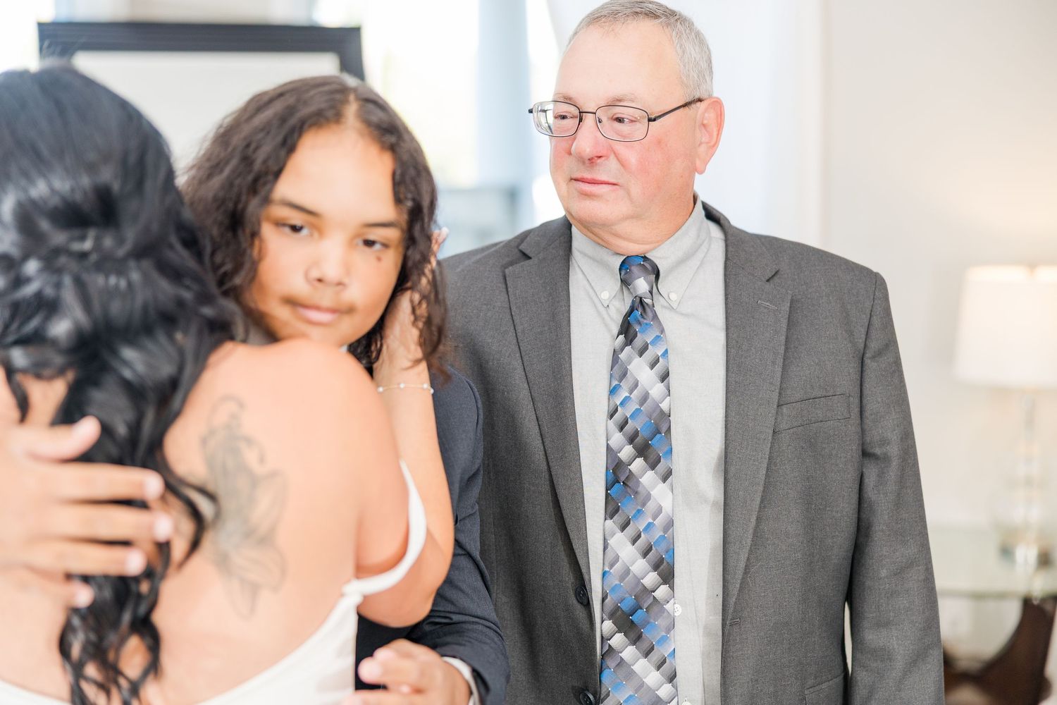 Emotional wedding moment captured in an intimate indoor setting wedding groom bride lake Gaston photographer light airy