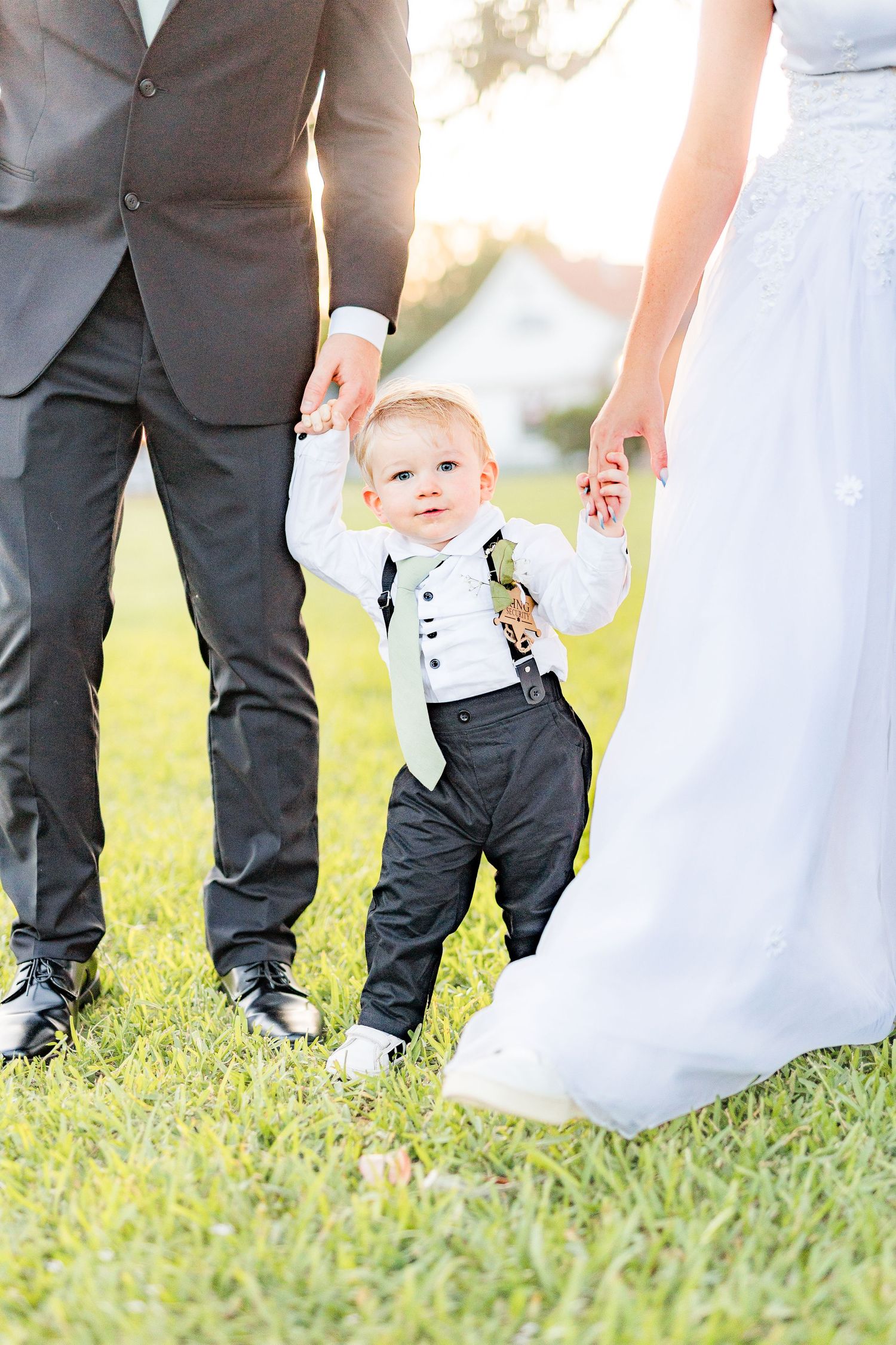 Wedding party members' feet shown walking on grass southport elopement wedding bride groom light and airy classic