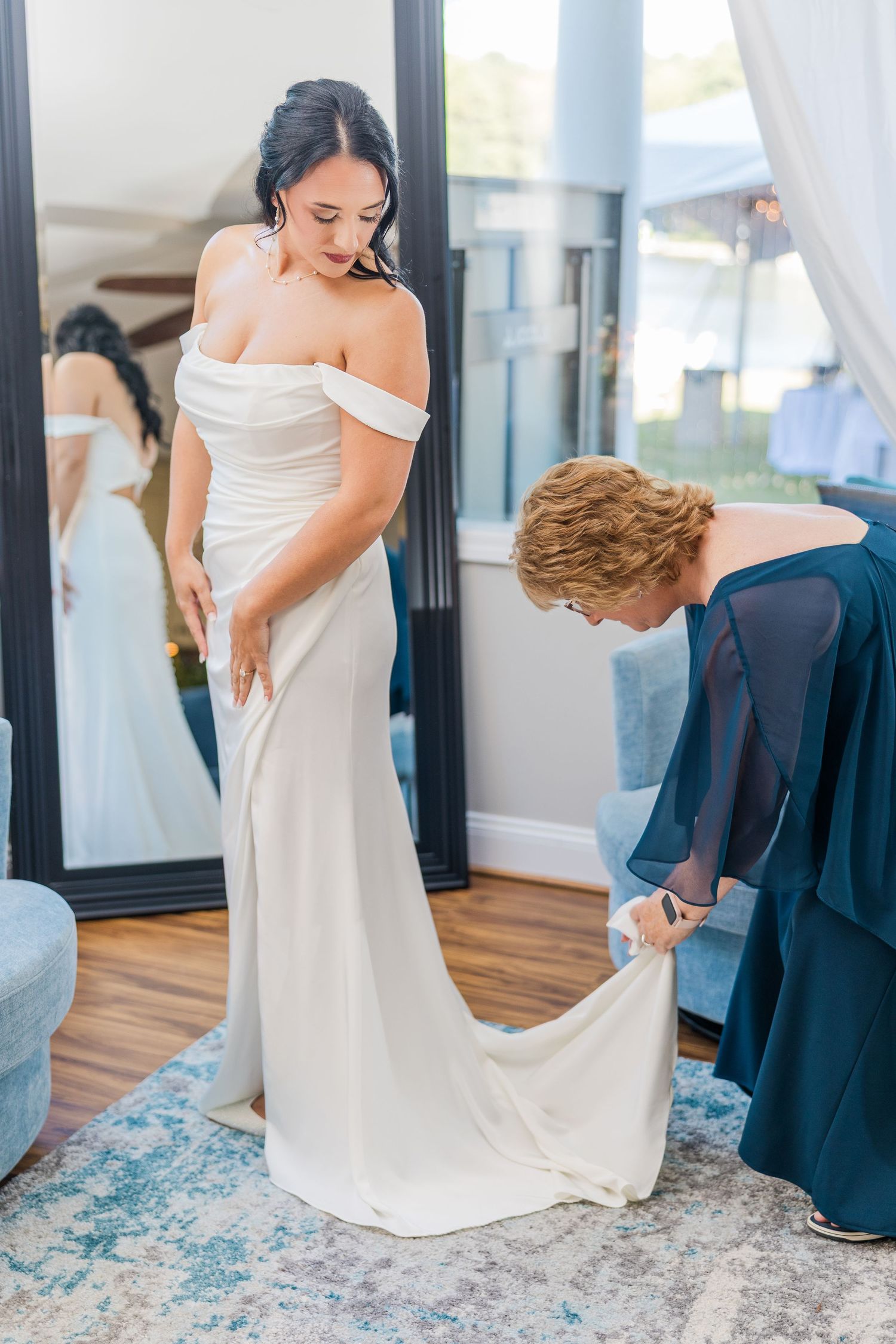 Wedding preparation scene with flowing white dress against blue decor wedding groom bride lake Gaston photographer light airy