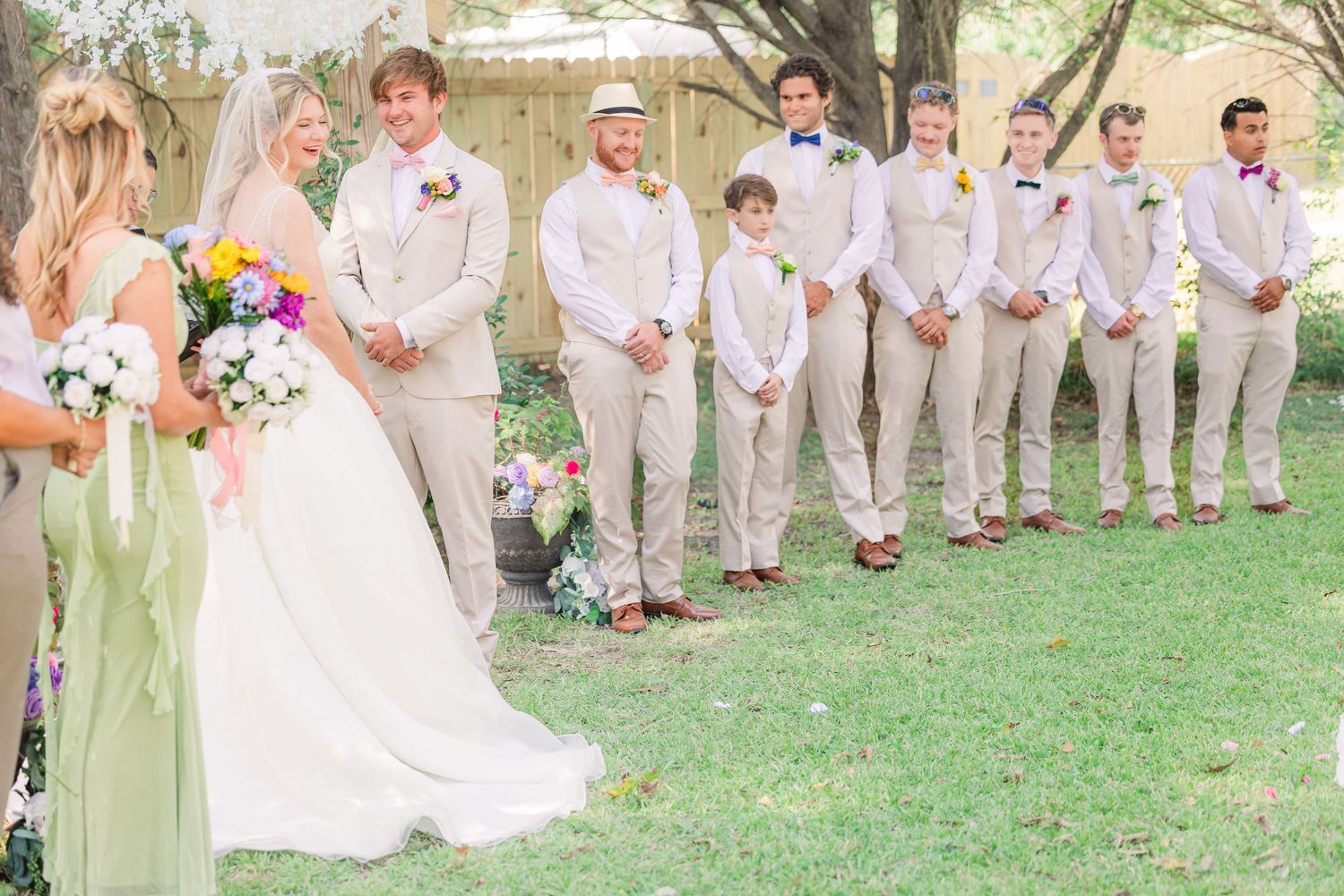 Wedding party in light beige suits wedding groom bride wilmington photographer light and airy classic Wrightsville Beach