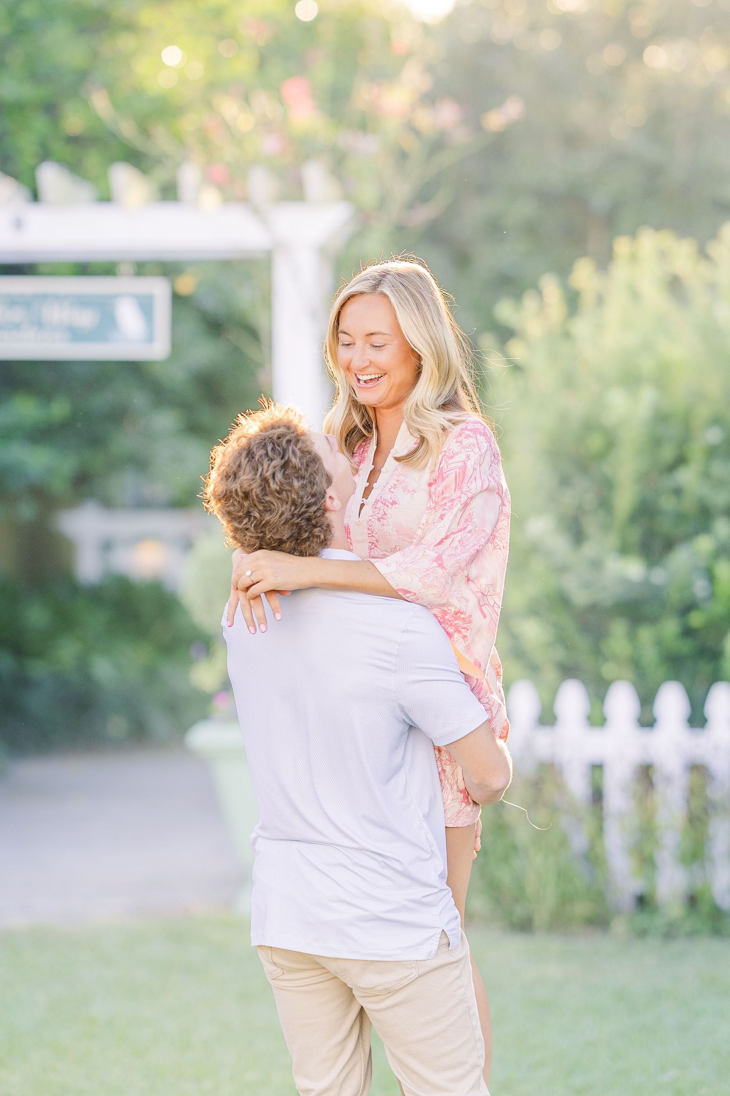 Playful outdoor portraits in a garden setting during golden hour.