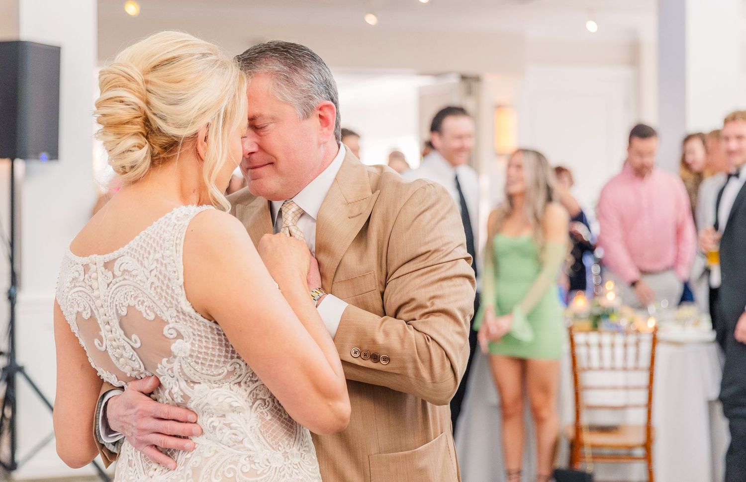 Emotional dance sequence at a wedding reception showing tender moments between guests in formal attire.