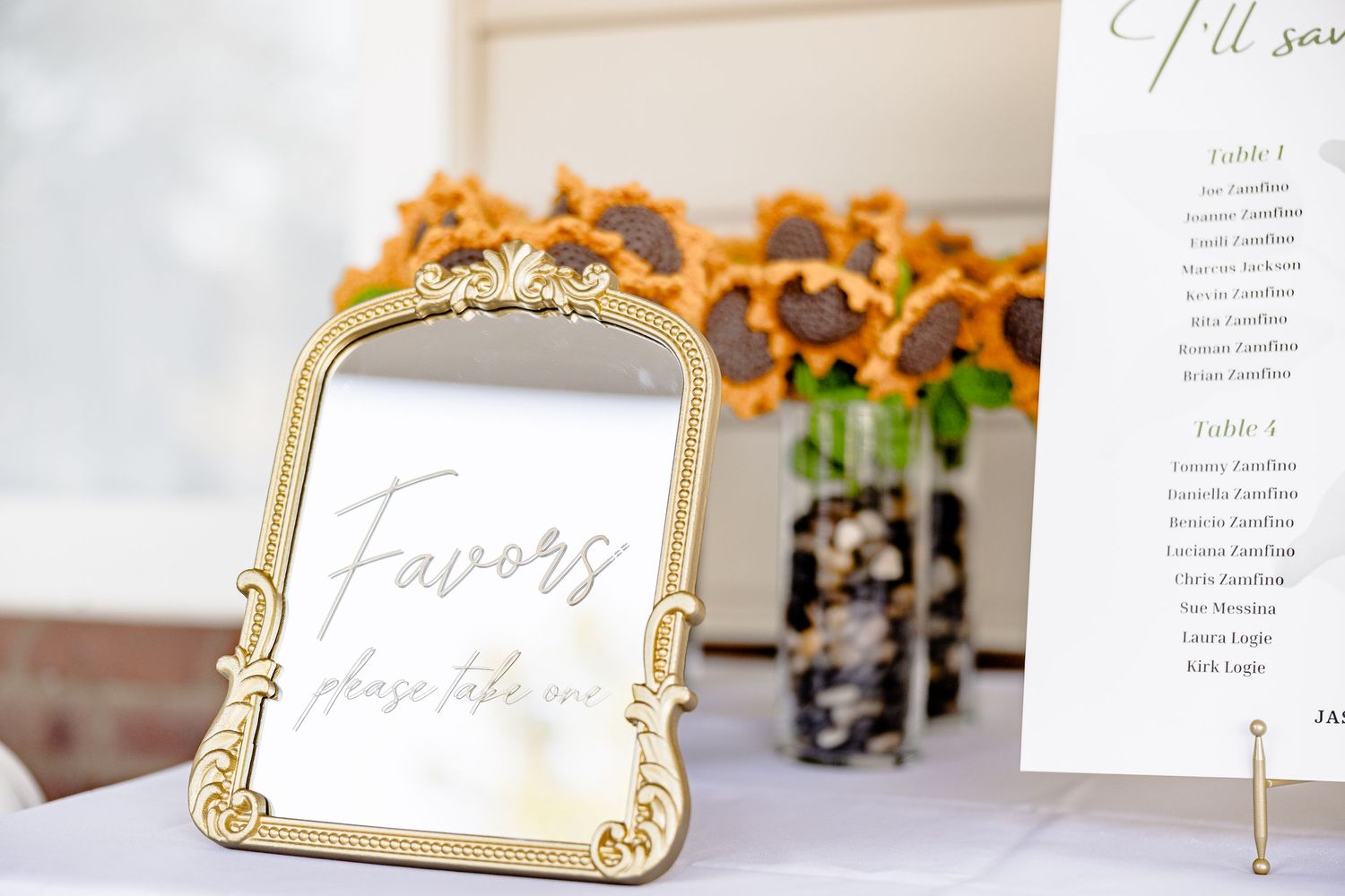 Wedding reception details showing menu cards and table numbers in gold frames wedding groom bride lake Gaston photographer light airy