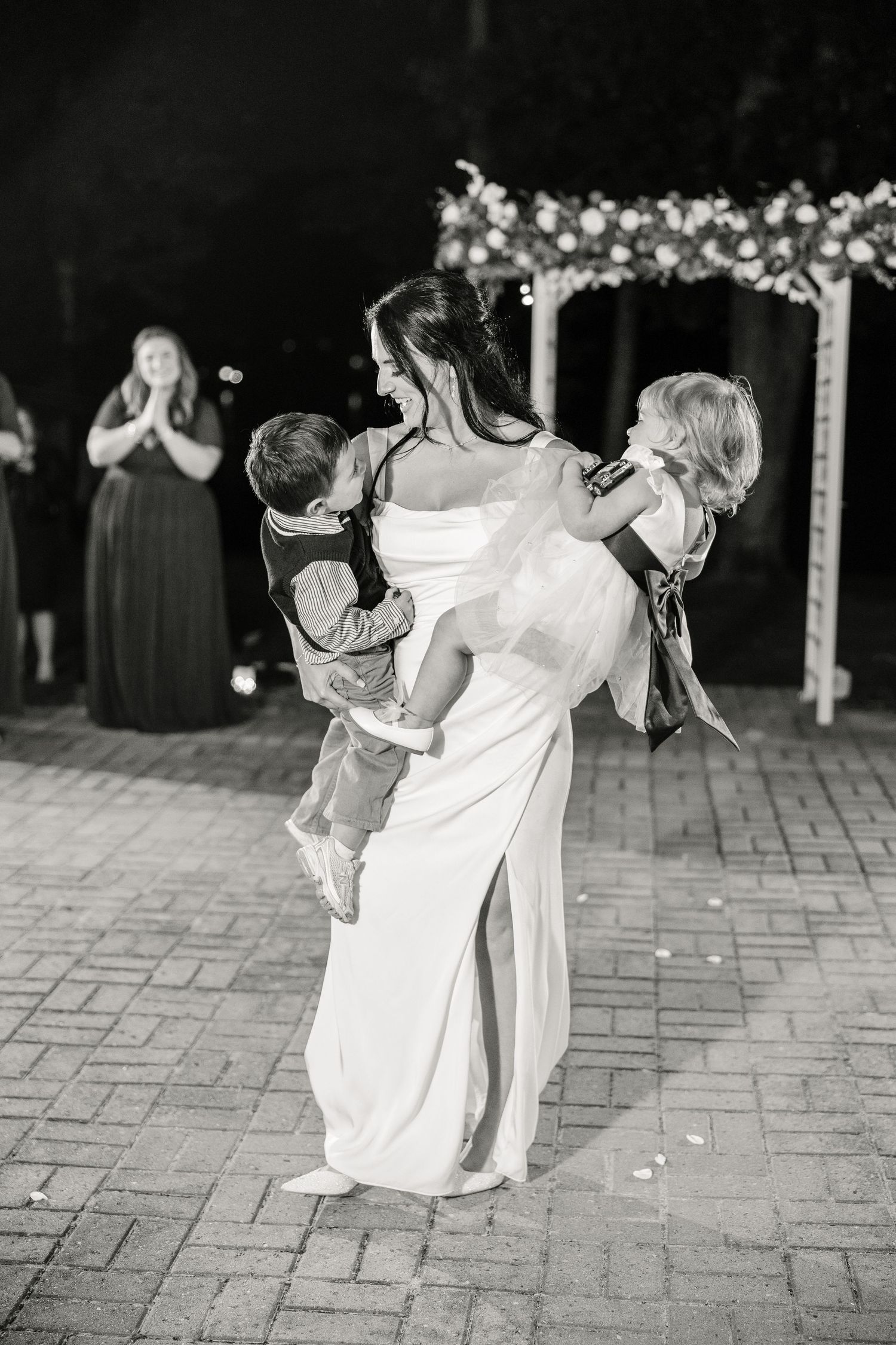 Wedding guests dancing in pairs on outdoor stone patio at night wedding groom bride lake Gaston photographer light airy