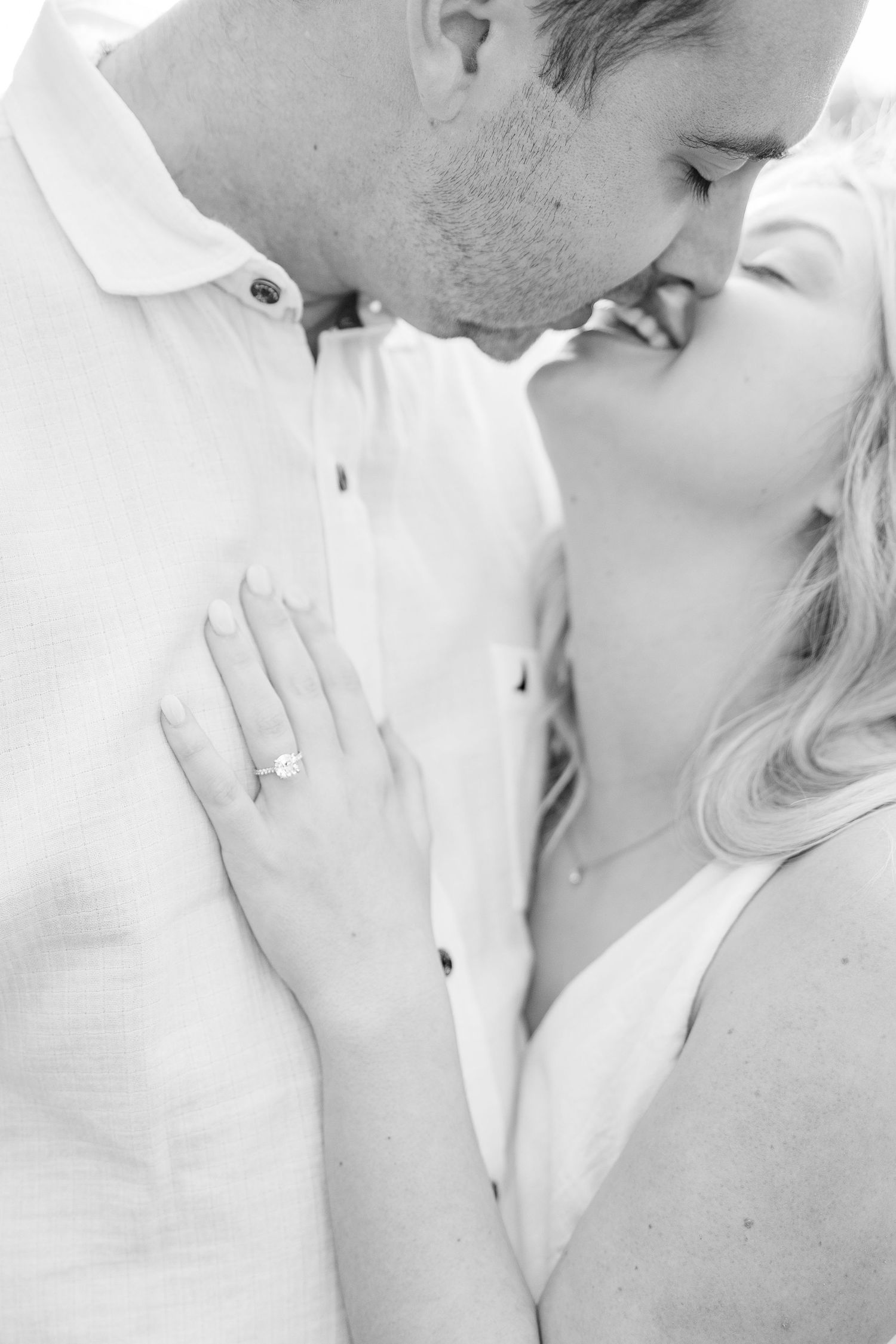 Intimate black and white portraits of a couple sharing tender moments together.