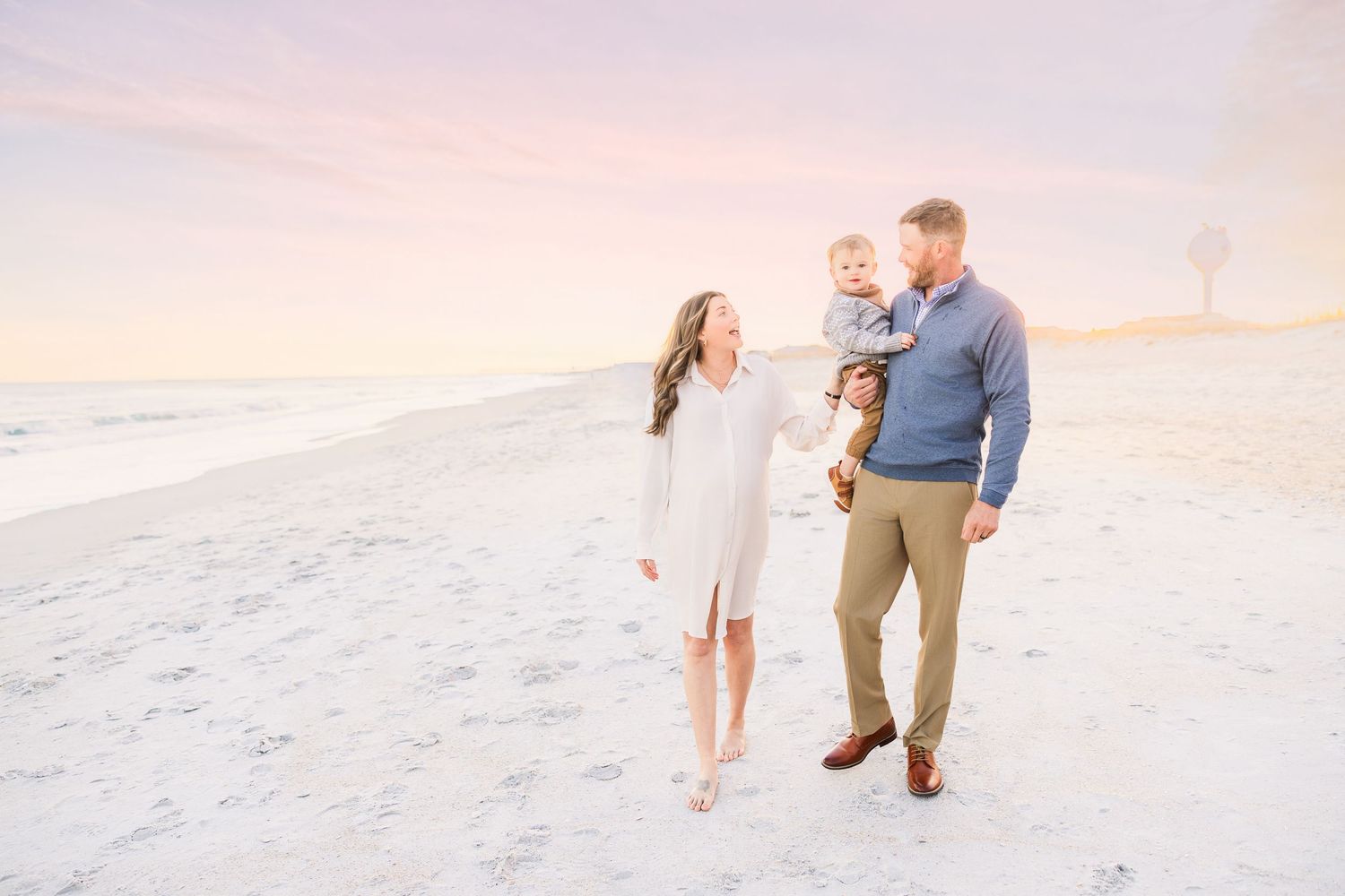 Romantic beach engagement session during golden hour sunset.