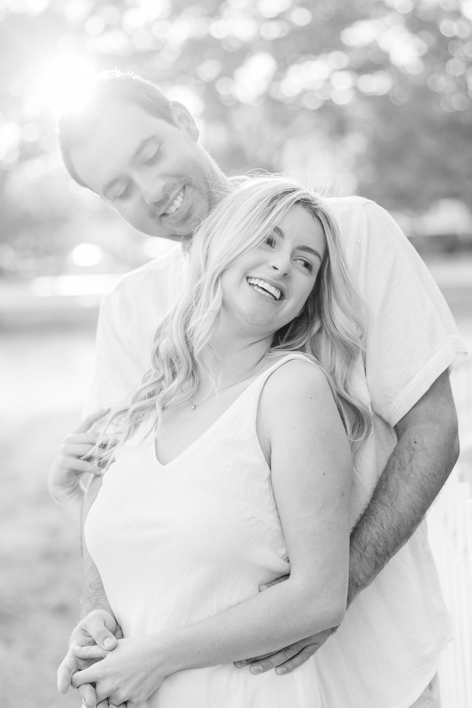Black and white photos capturing joyful intimate moments between a couple outdoors.