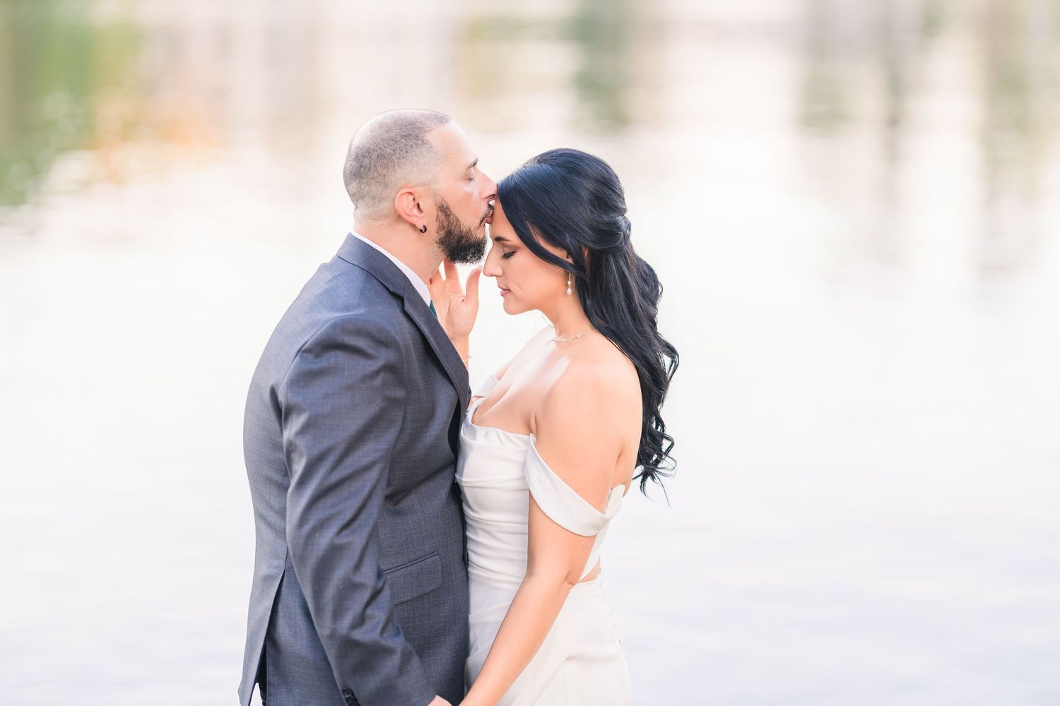 Romantic wedding portraits captured against a waterfront backdrop wedding groom bride lake Gaston photographer light airy