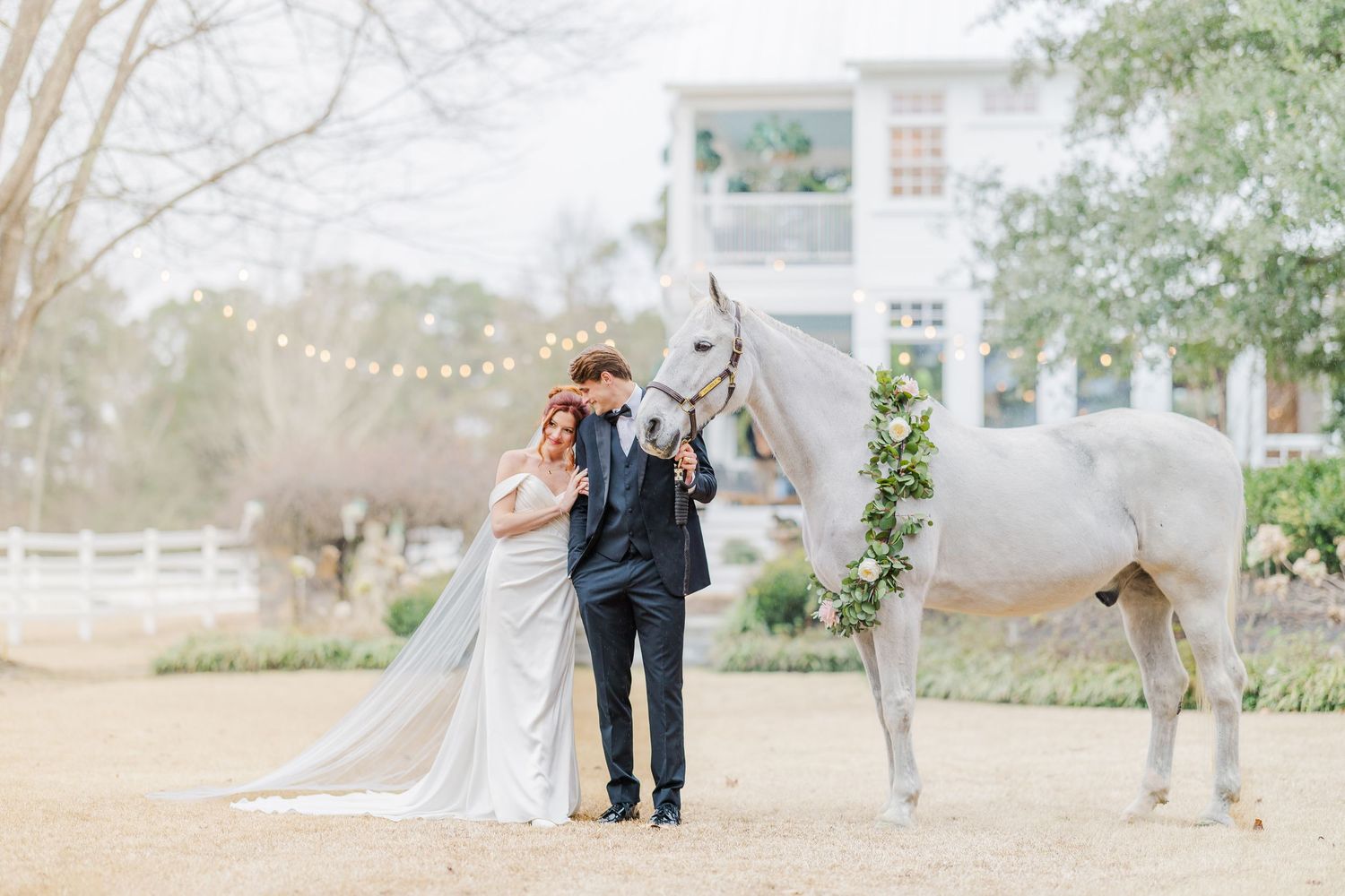 Wedding party members gather for photos in a scenic outdoor garden setting.