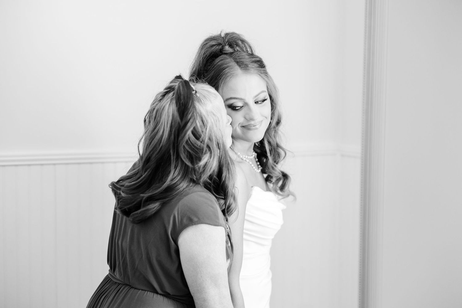 Black and white intimate moment captured during wedding preparations wedding groom bride wilmington North Carolina photographer light airy