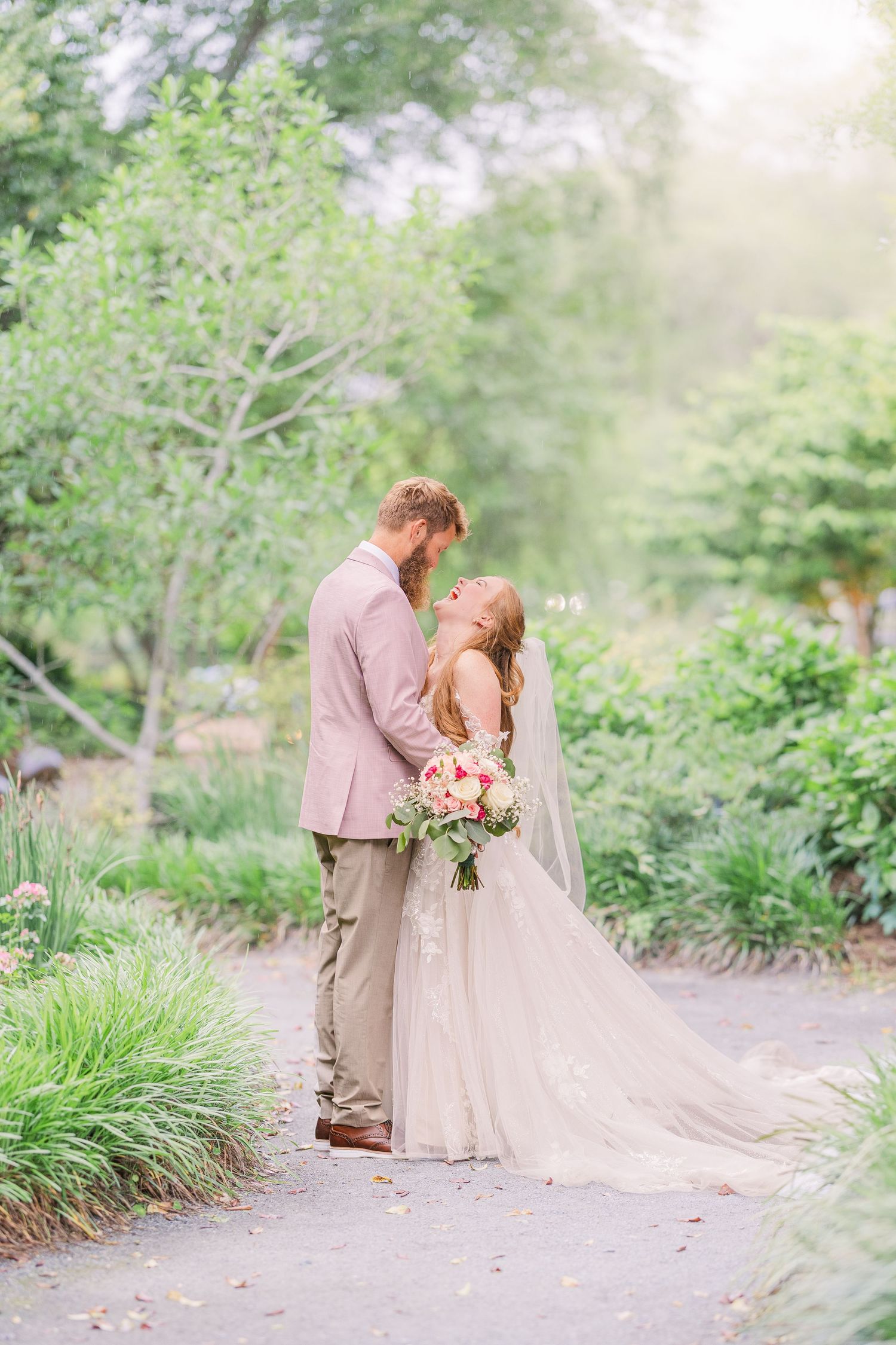 Garden pathway wedding photos with soft natural lighting and blooming spring foliage in harborway gardens in Wrightsville Beach, nc