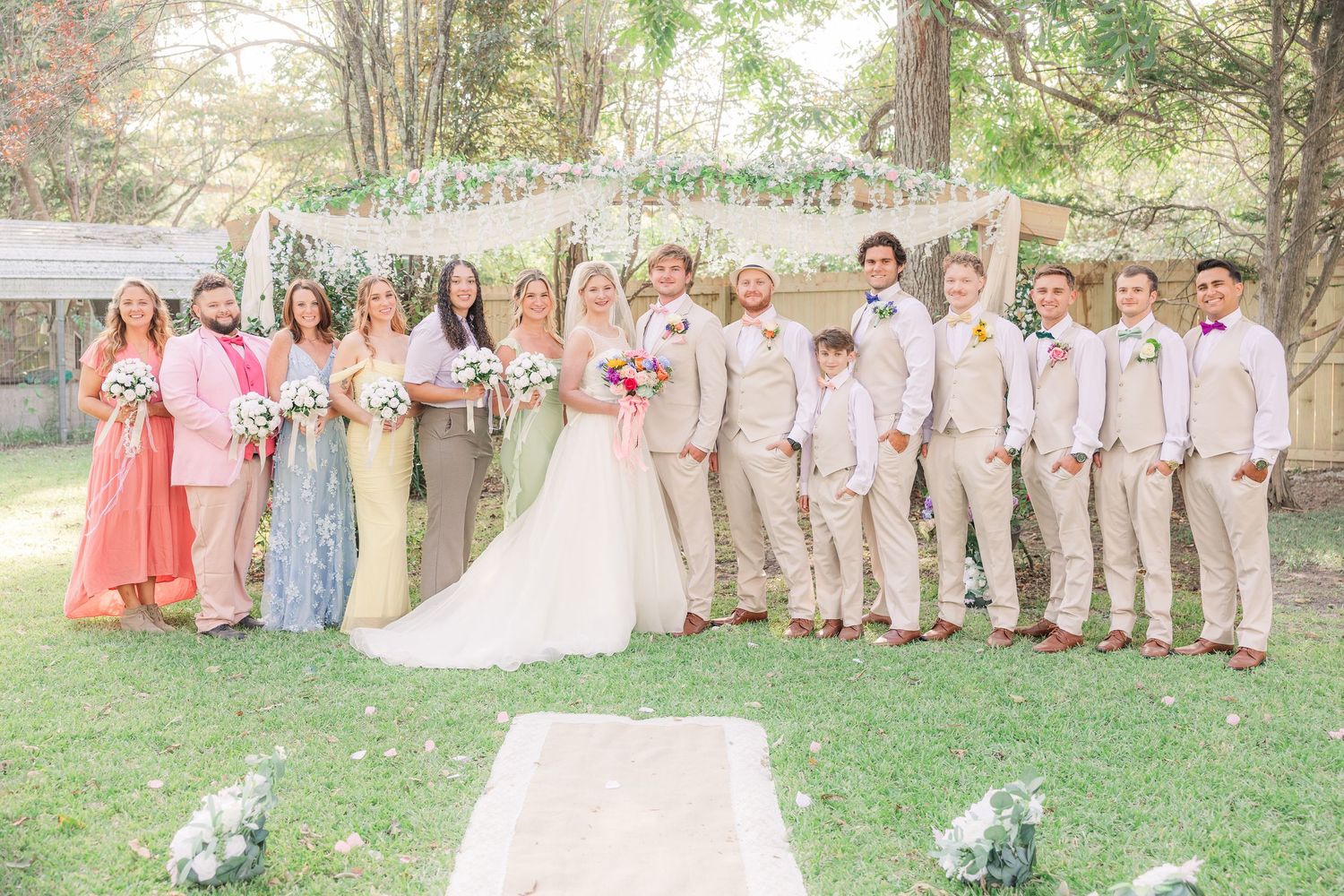 Wedding party poses outdoors with bridesmaidswedding groom bride wilmington photographer light and airy classic Wrightsville Beach
