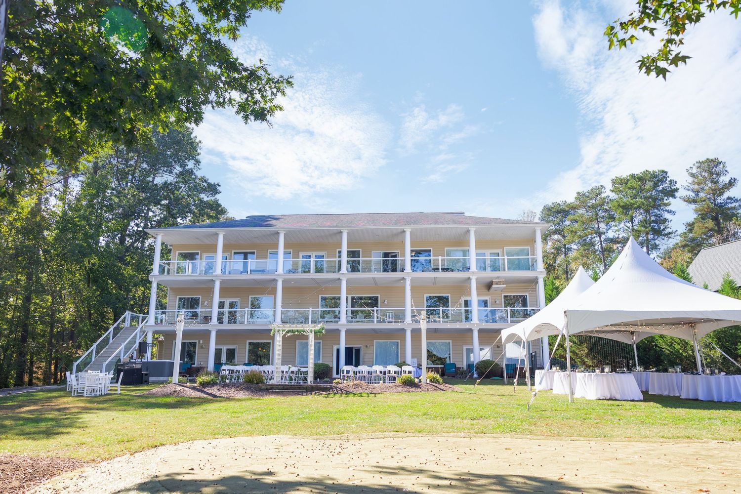 Southern plantation-style venue with white columns and wraparound porch for outdoor wedding wedding groom bride lake Gaston photographer