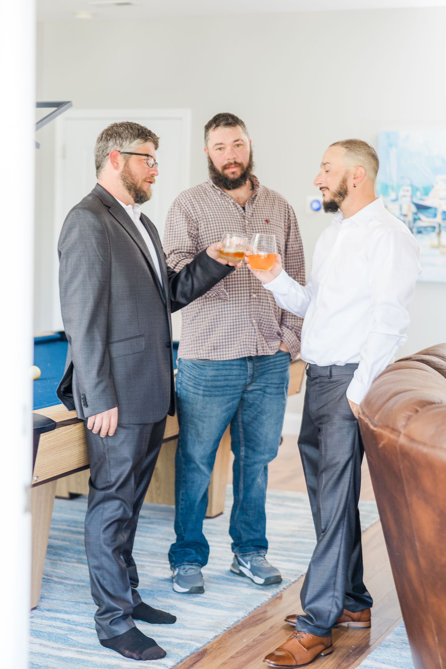 Group of people in formal attire socializing with drinks wedding groom bride lake Gaston photographer light airy