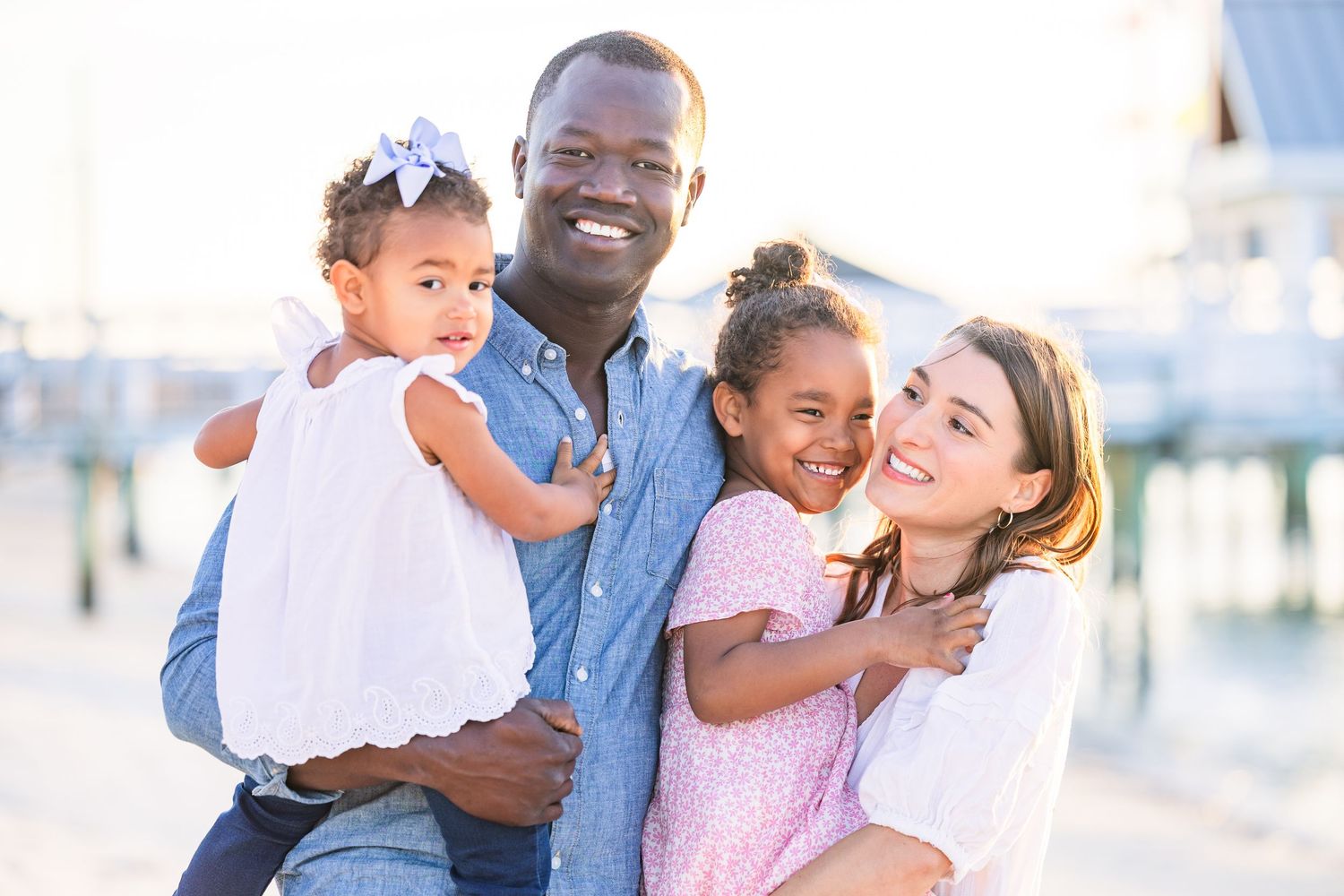Family enjoying tender moments together during a beach photo session.