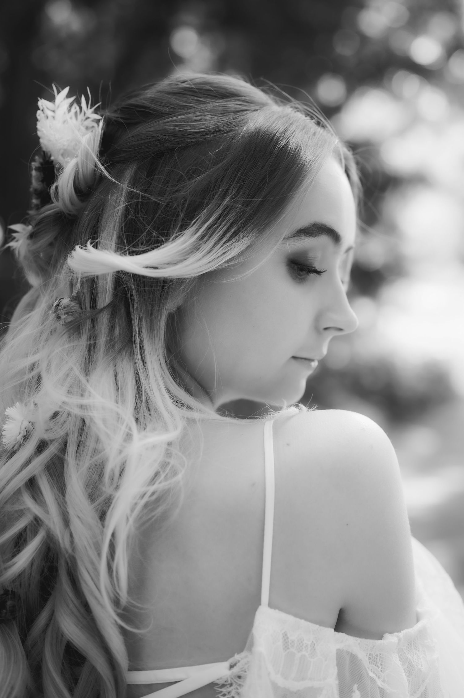 Black and white portrait of a bride with her hair moving in natural light.