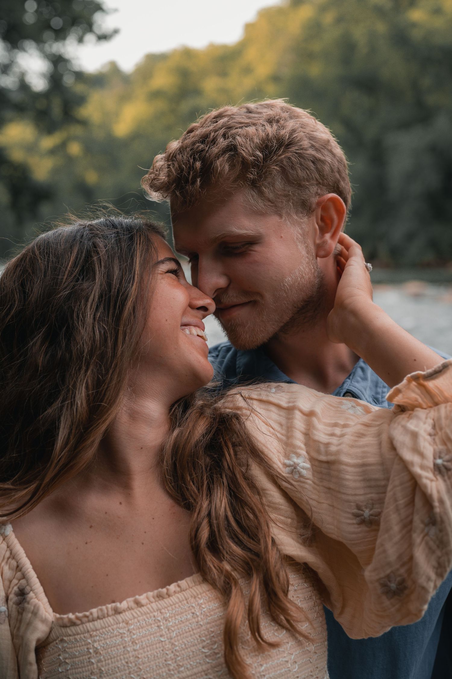 Couple standing together outdoors during golden hour.