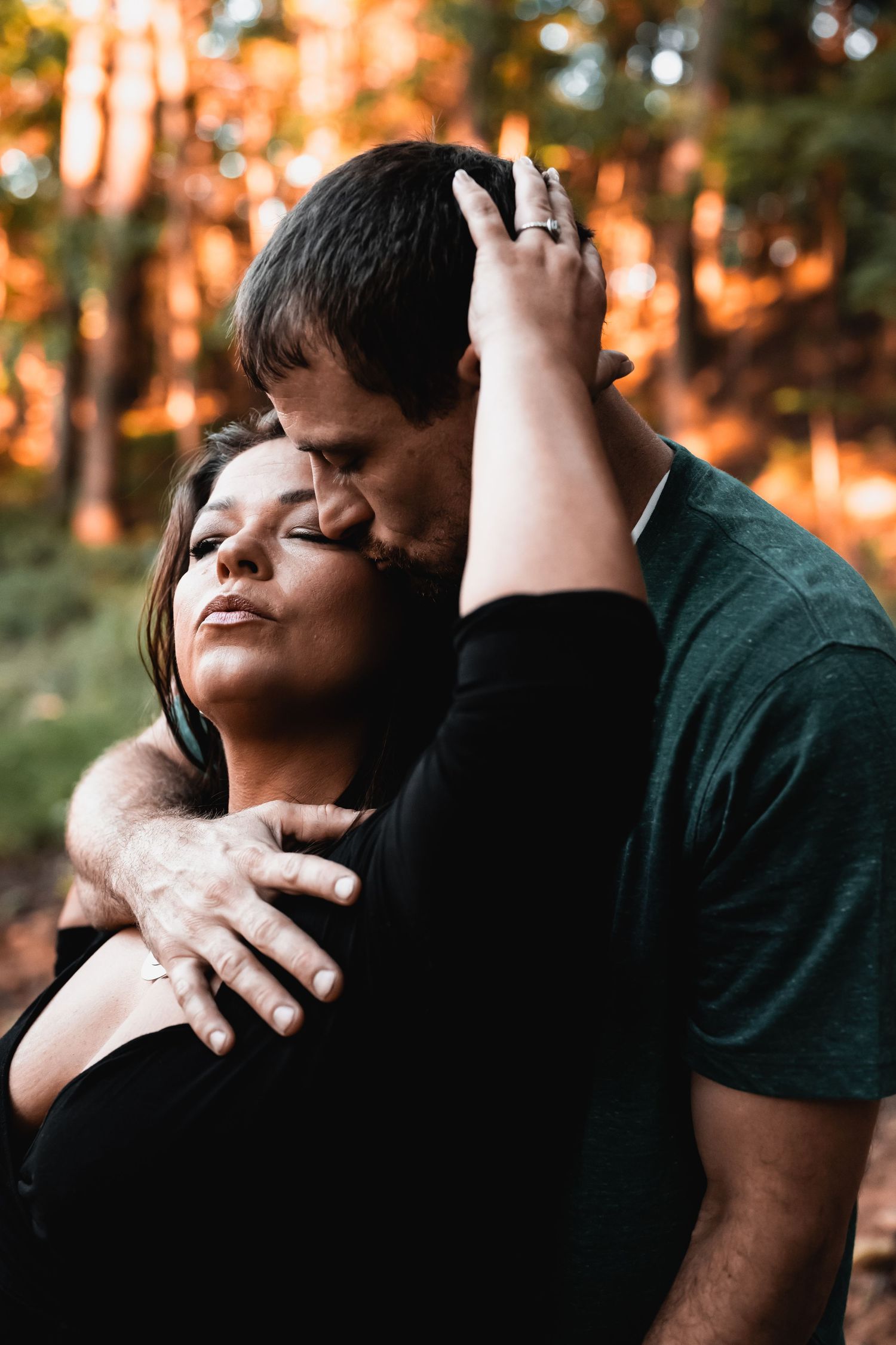 Couple embracing during a sunset portrait session with warm evening light.