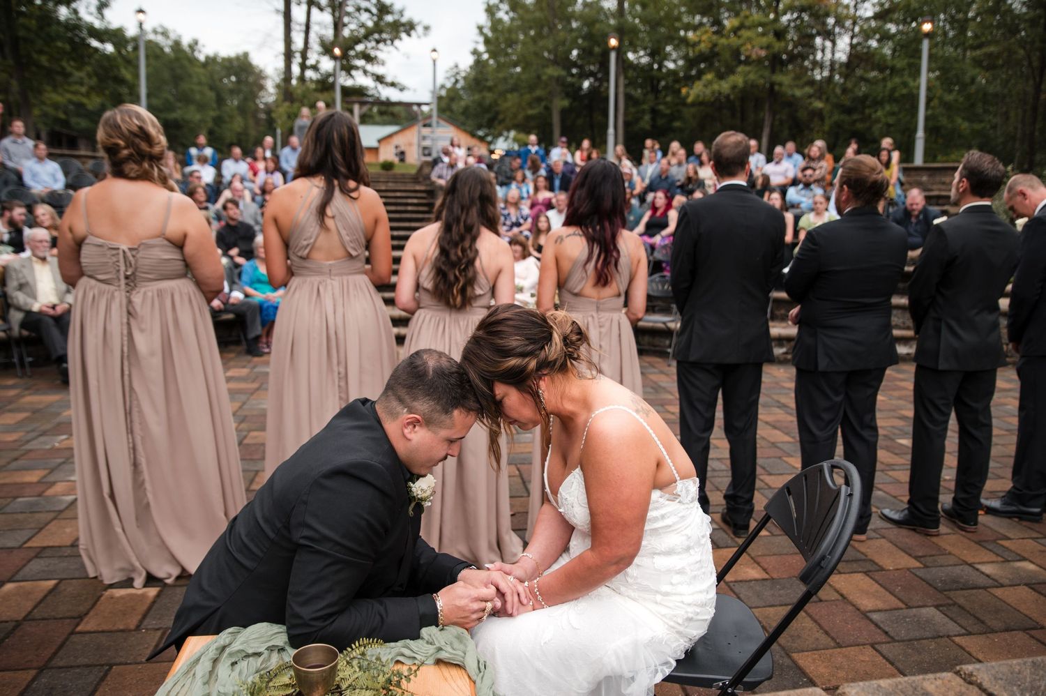 Wedding guests and bridal party gathered on an outdoor deck during the reception.