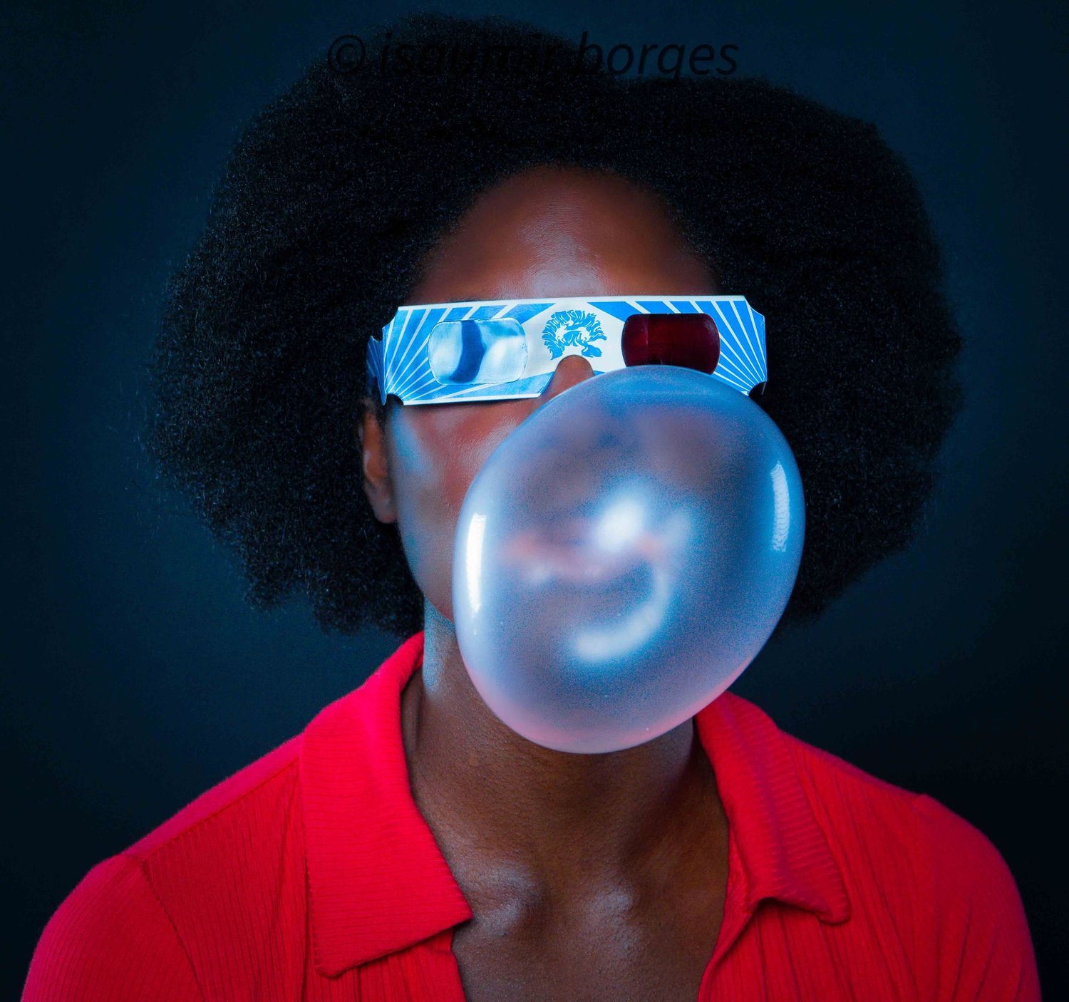 Series of portraits showing someone blowing bubble gum in blue lighting while wearing red.