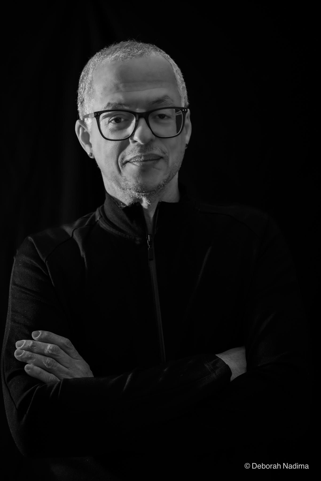 Black and white portrait series showing different poses and expressions against dark background.