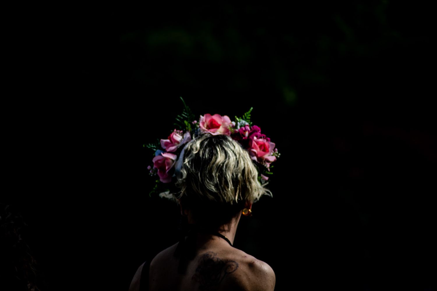 Dramatic portrait series featuring floral crown and dark background creating moody atmosphere.