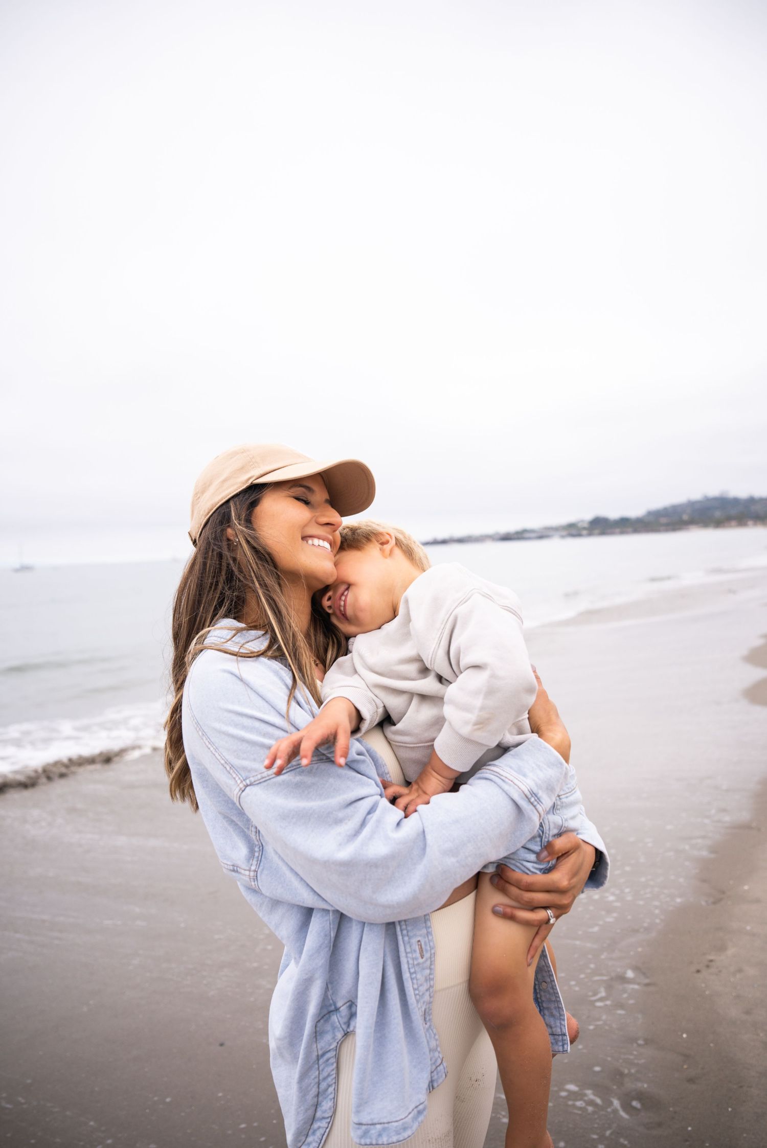 Two people sharing an intimate moment while embracing on a misty beach.