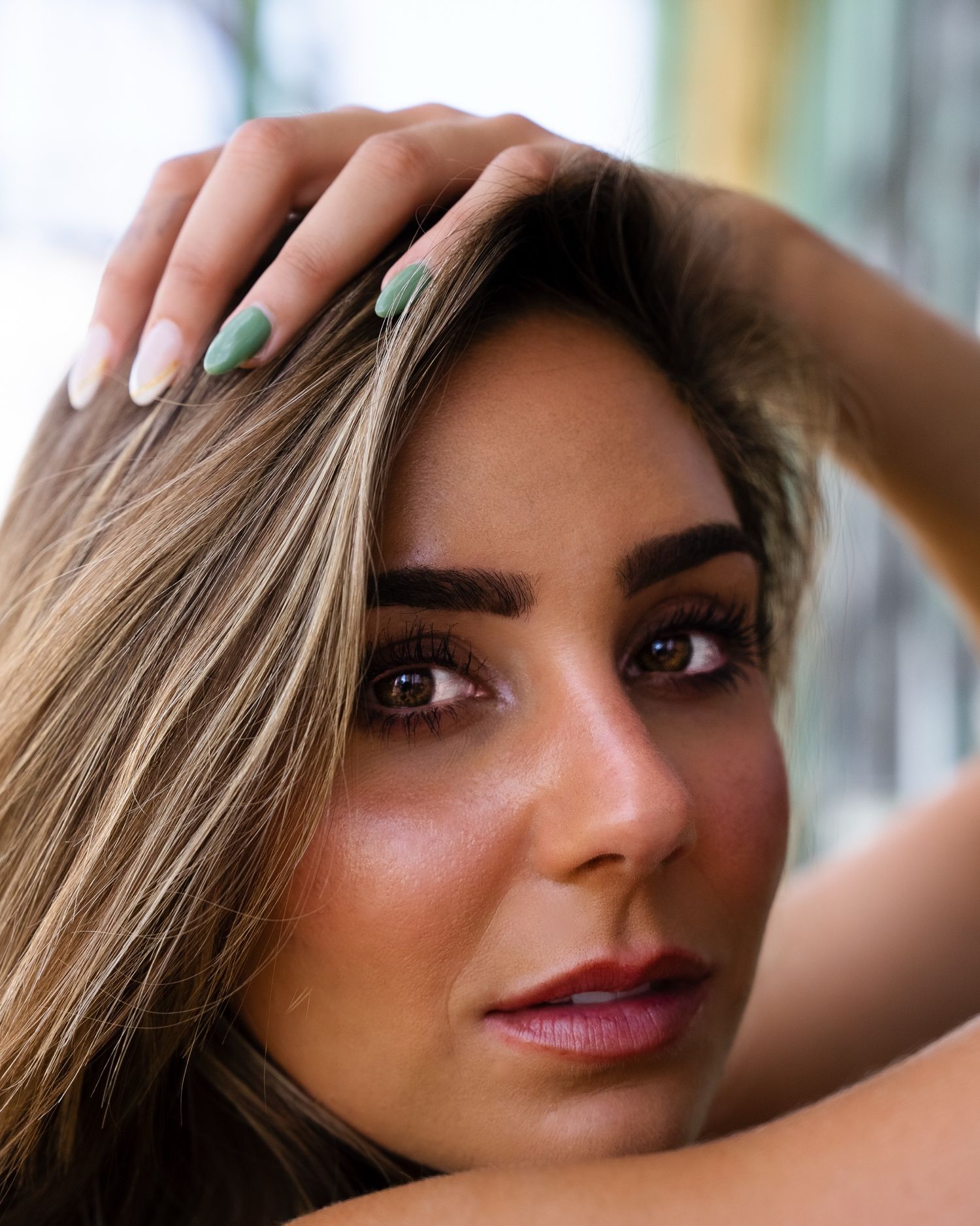 Close-up beauty portrait showing eyes and makeup in soft lighting.