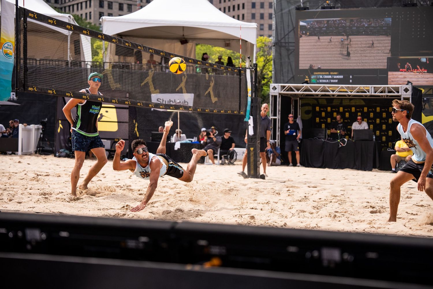 Beach volleyball action shots during competitive match on sandy court.