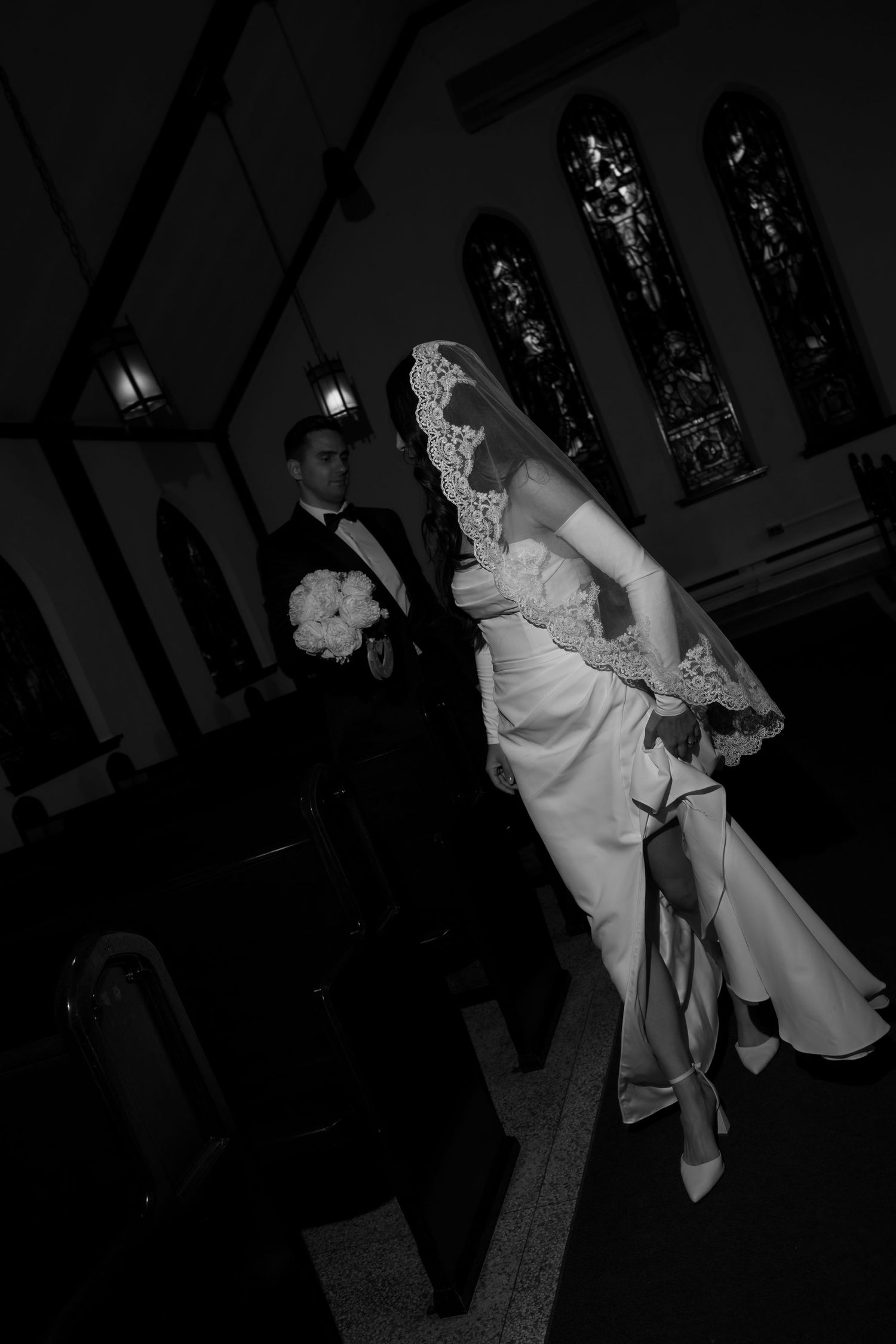 Dramatic black and white dance photos from wedding reception in church hall.