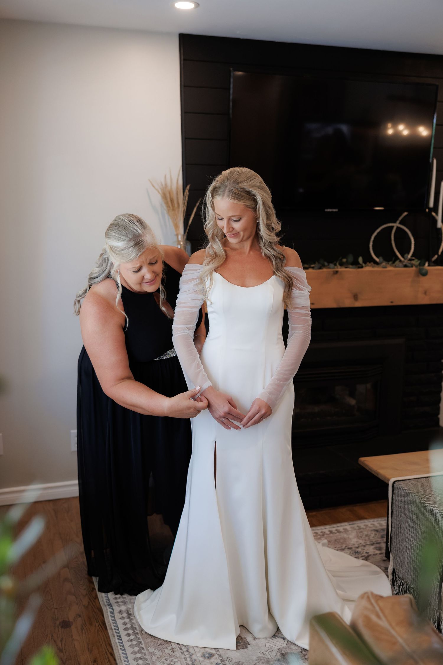 Wedding dress preparation scene in a modern interior room with white walls.