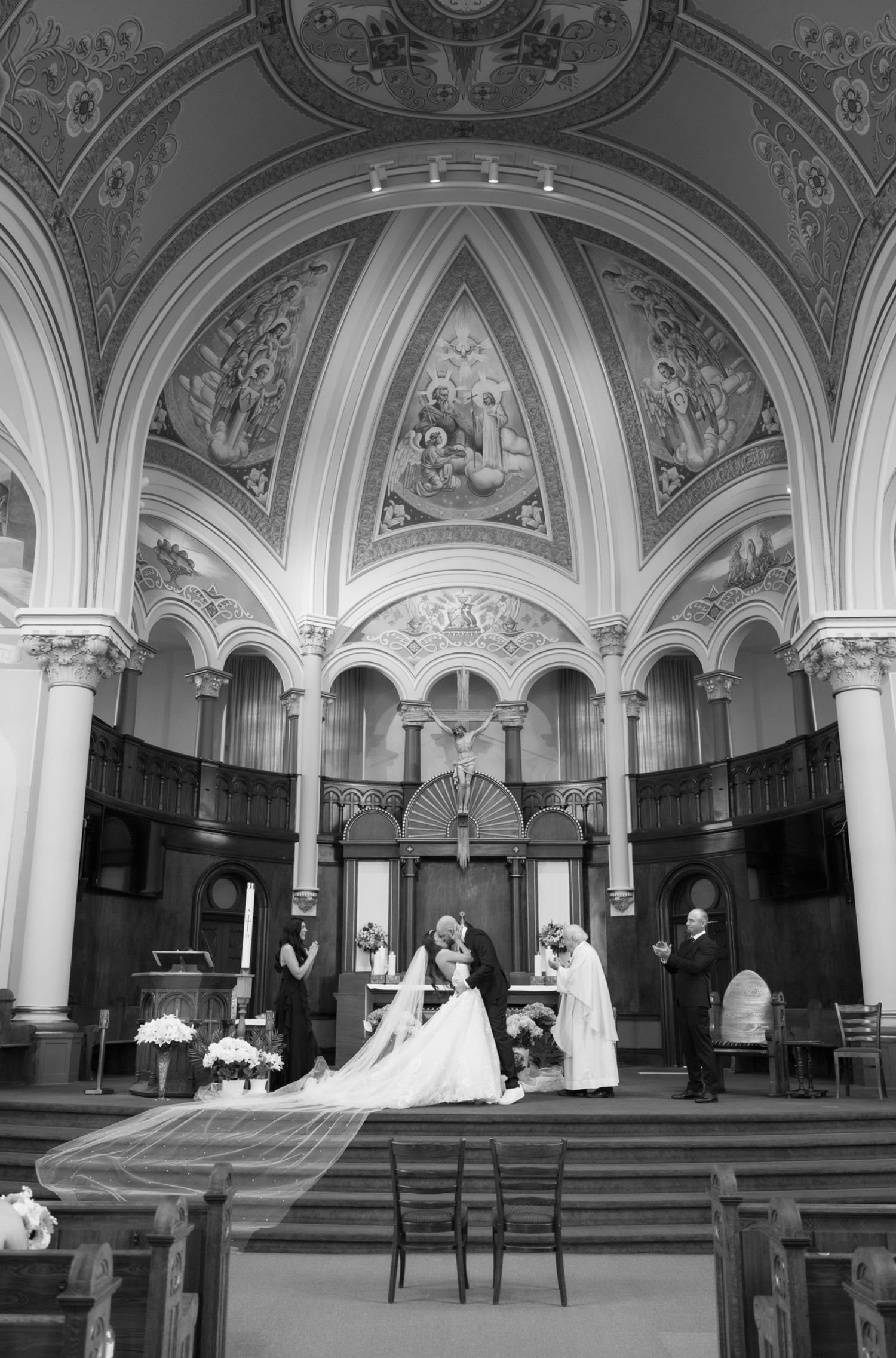 Black and white panoramic series showing a traditional church ceremony taking place in an ornate vaulted interior.