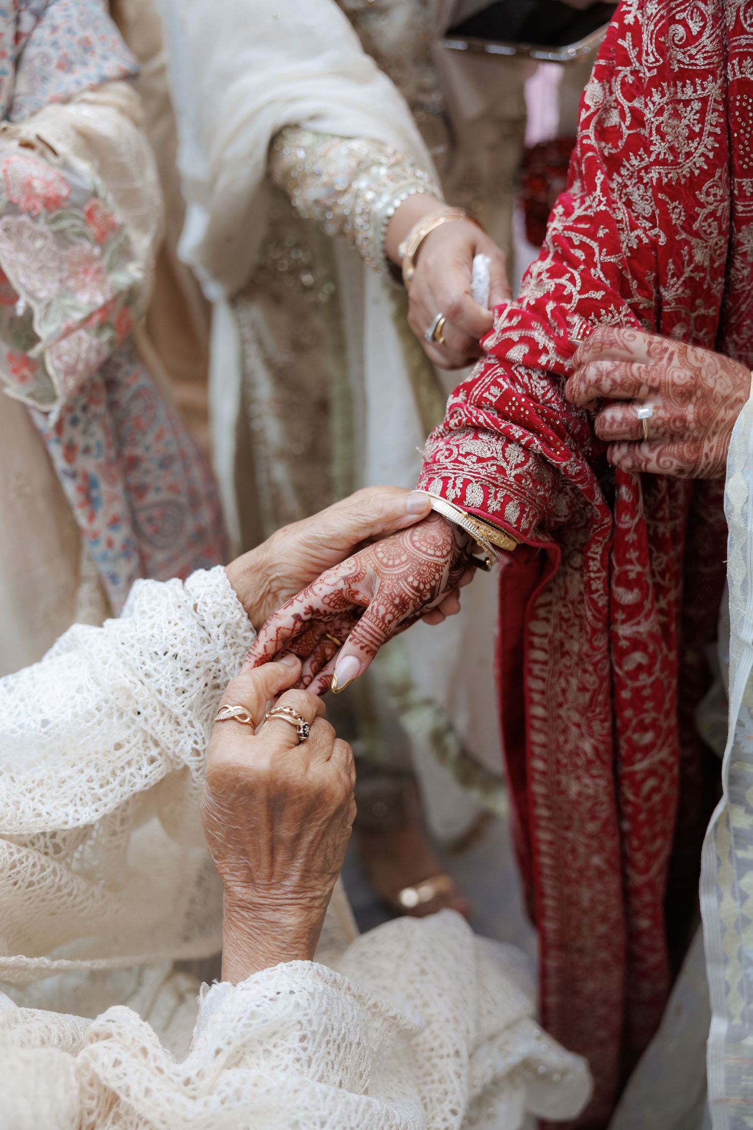 Close-up of intricate henna designs and lace details during a traditional wedding ceremony.