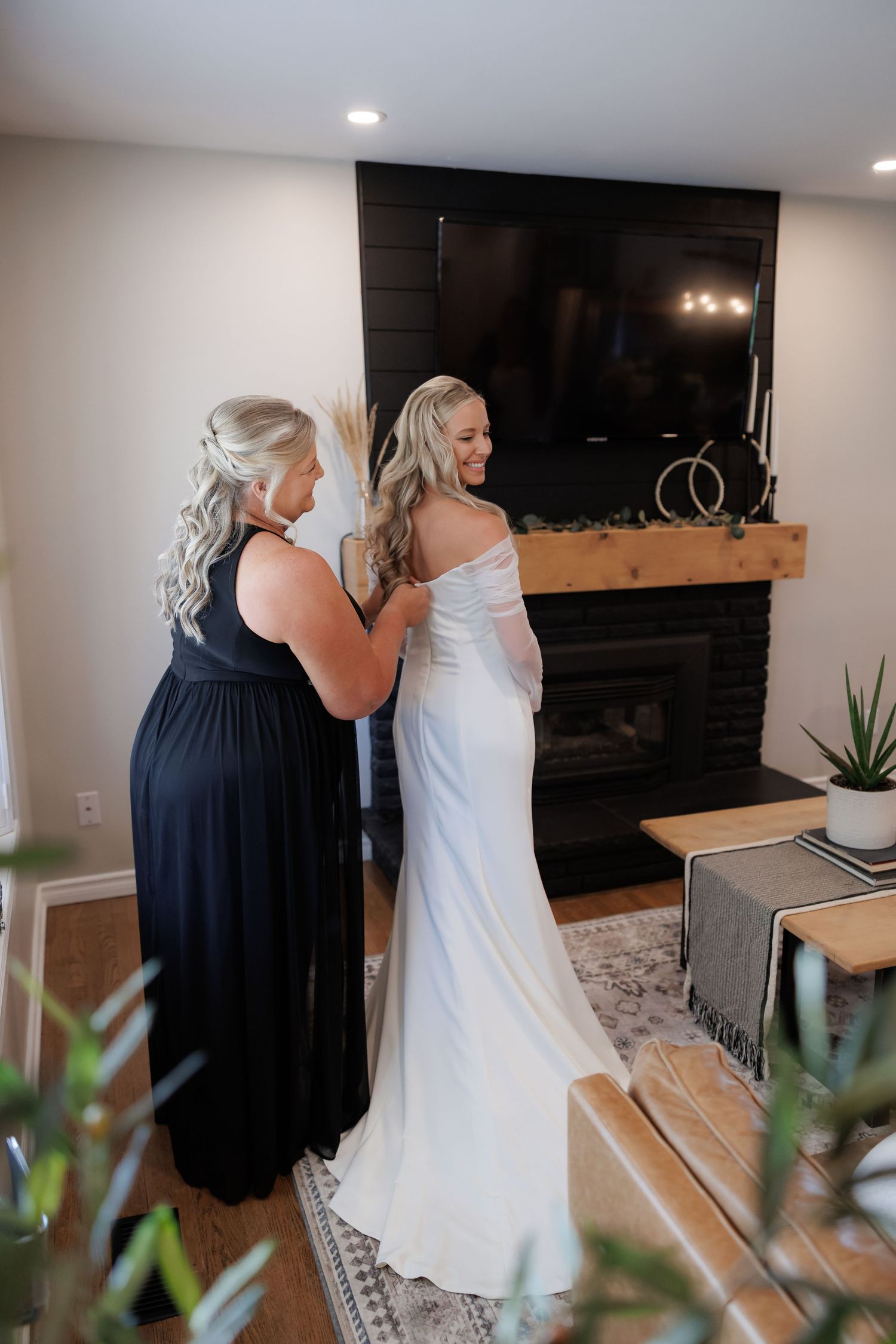 Wedding dress fitting moment captured in an elegant indoor setting.