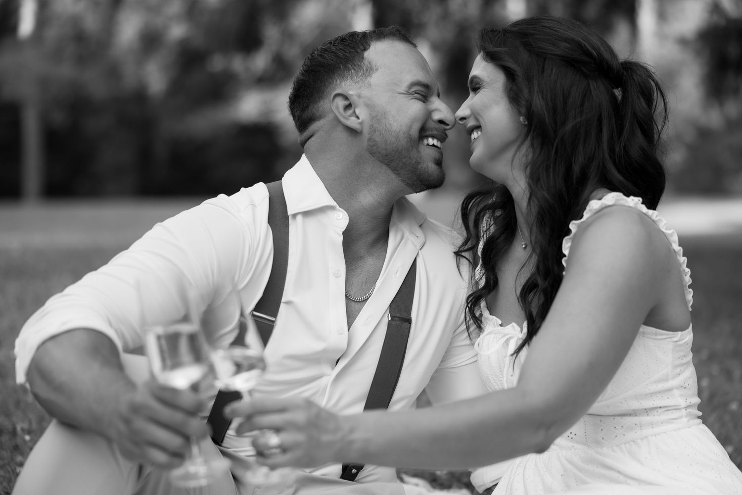 Black and white intimate moment between couple during outdoor picnic.