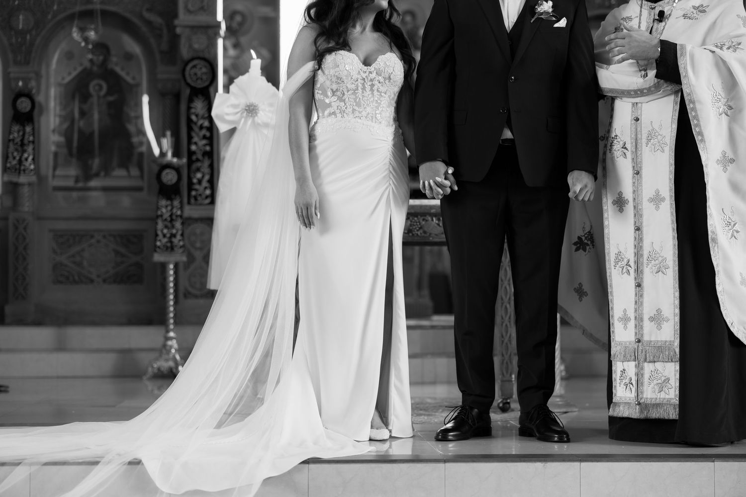 Wedding ceremony procession in traditional Orthodox church setting.