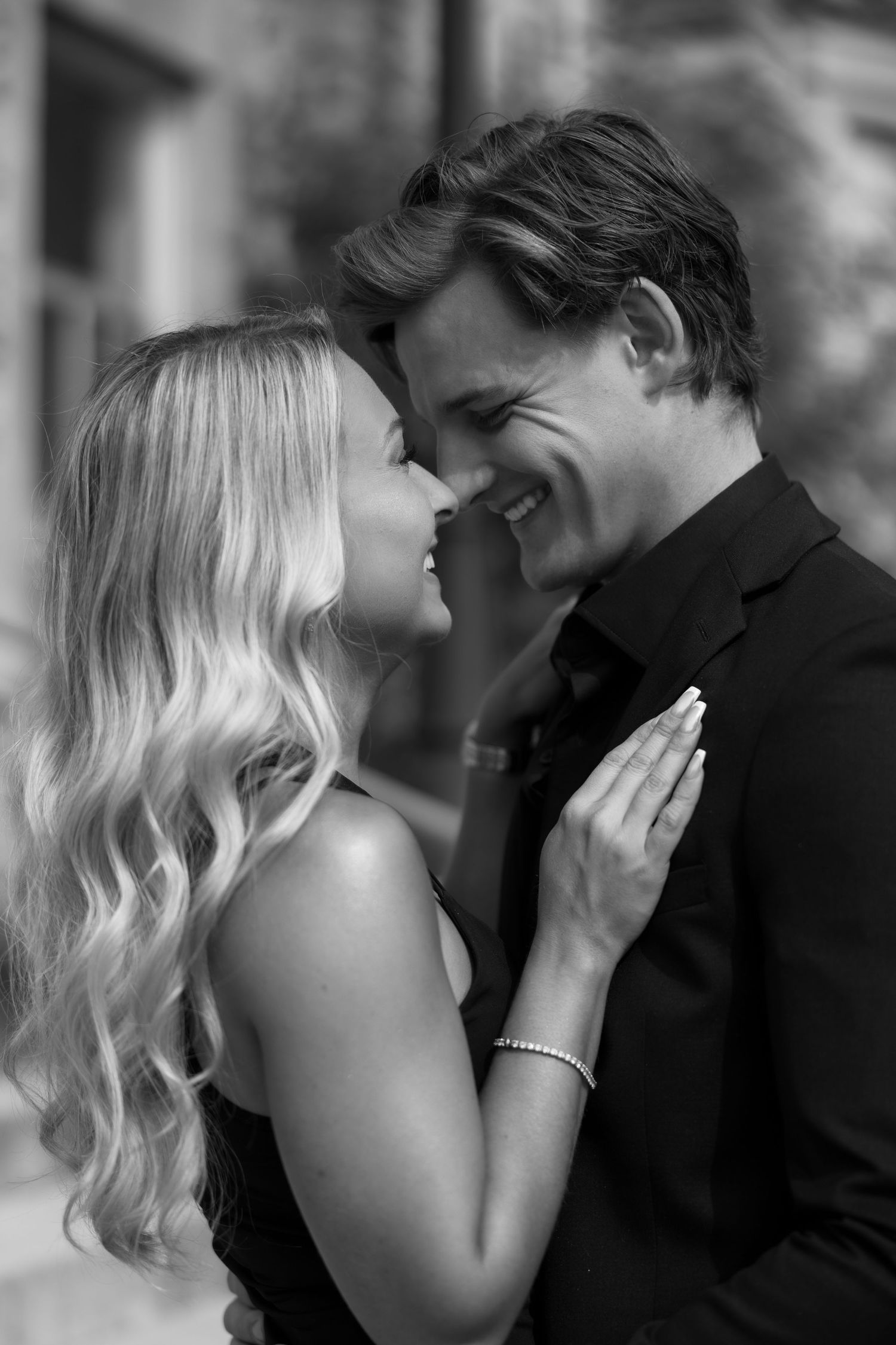 Intimate black and white portrait of a couple sharing a tender moment.